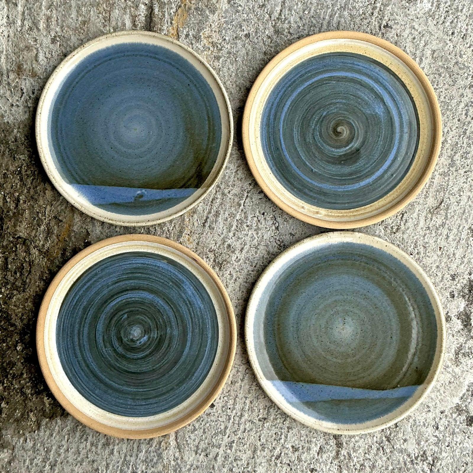 Infuse your table with artisanal elegance and a touch of bohemian spirit with this stunning set of four vintage studio pottery plates by the acclaimed ceramicist Jess Lord. Each plate is a unique work of art, hand-thrown and masterfully glazed to