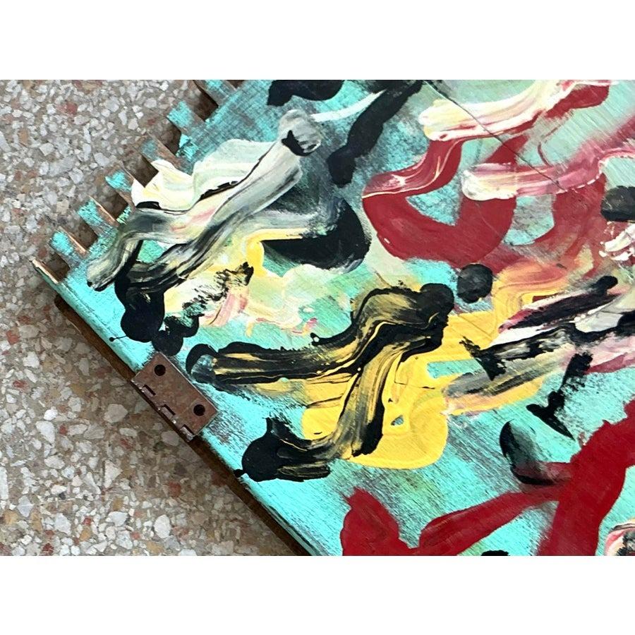 This captivating vintage painting by Purvis Young showcases the artist’s signature expressive style, with dynamic brushstrokes and vibrant colors that bring life and movement to this unique piece. Painted on a reclaimed wooden door, this artwork