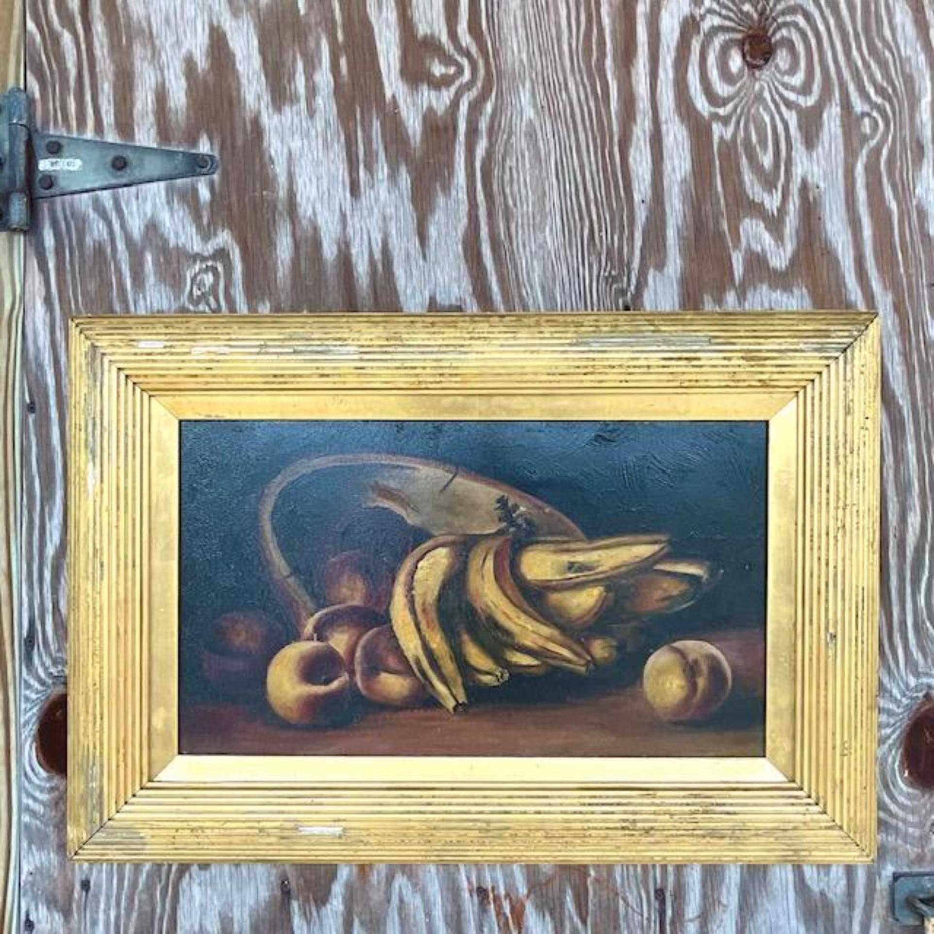 A striking vintage original oil painting on board. A chic still life of bananas and other small fruits. A chic distressed period frame. Acquired from a Palm Beach estate.