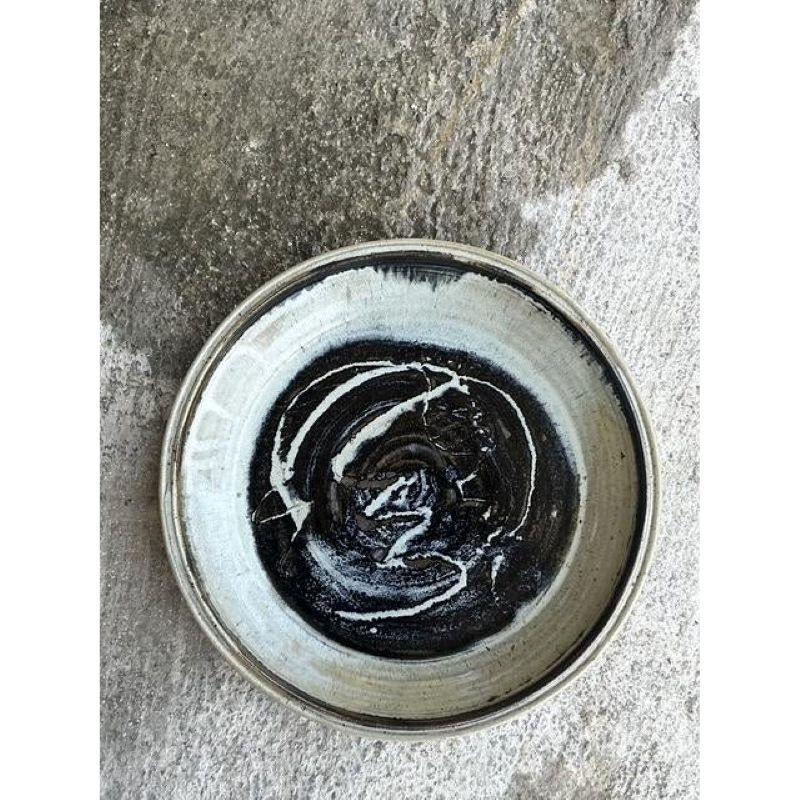 Embrace the soulful beauty of handcrafted design with this exceptional large-scale studio pottery platter. A true piece of functional art, this charger is masterfully hand-thrown from substantial stoneware, with the artist's touch evident in every