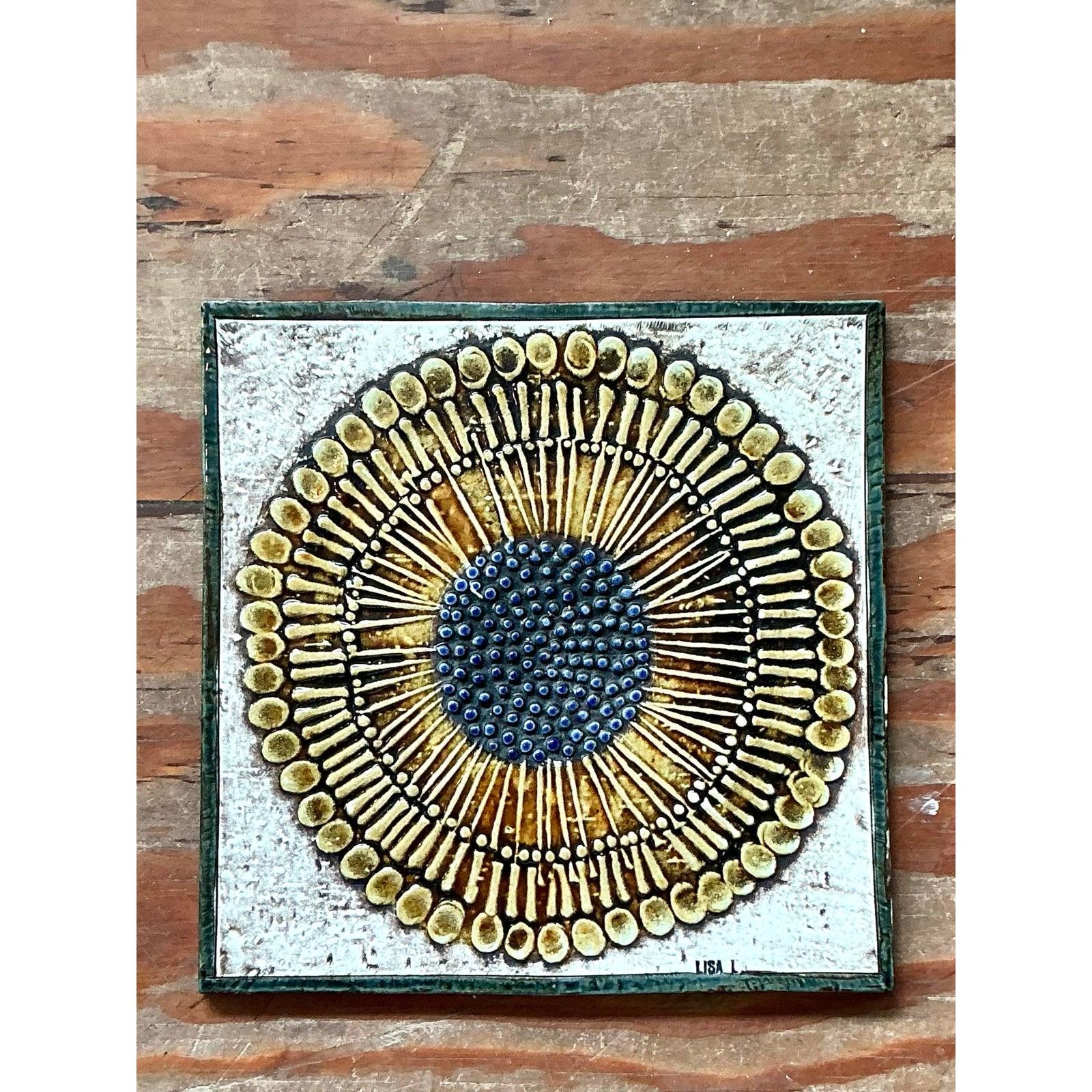 This engaging ceramic art tile is a distinctive example of high-relief studio pottery, echoing the popular Scandinavian folk art aesthetic of the Mid-Century period. The piece features two heavily stylized birds, rendered in intricate detail with
