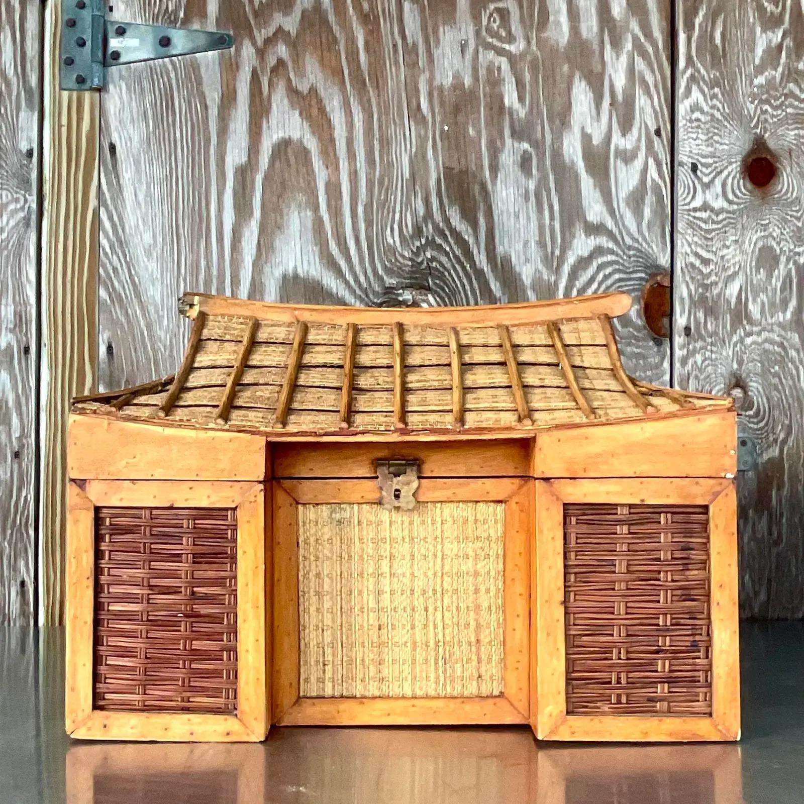 An incredible vintage Boho woven rattan trunk. A chic pagoda shape that open at the roofline. Really unusual and beautiful. Acquired from a Palm Beach estate.