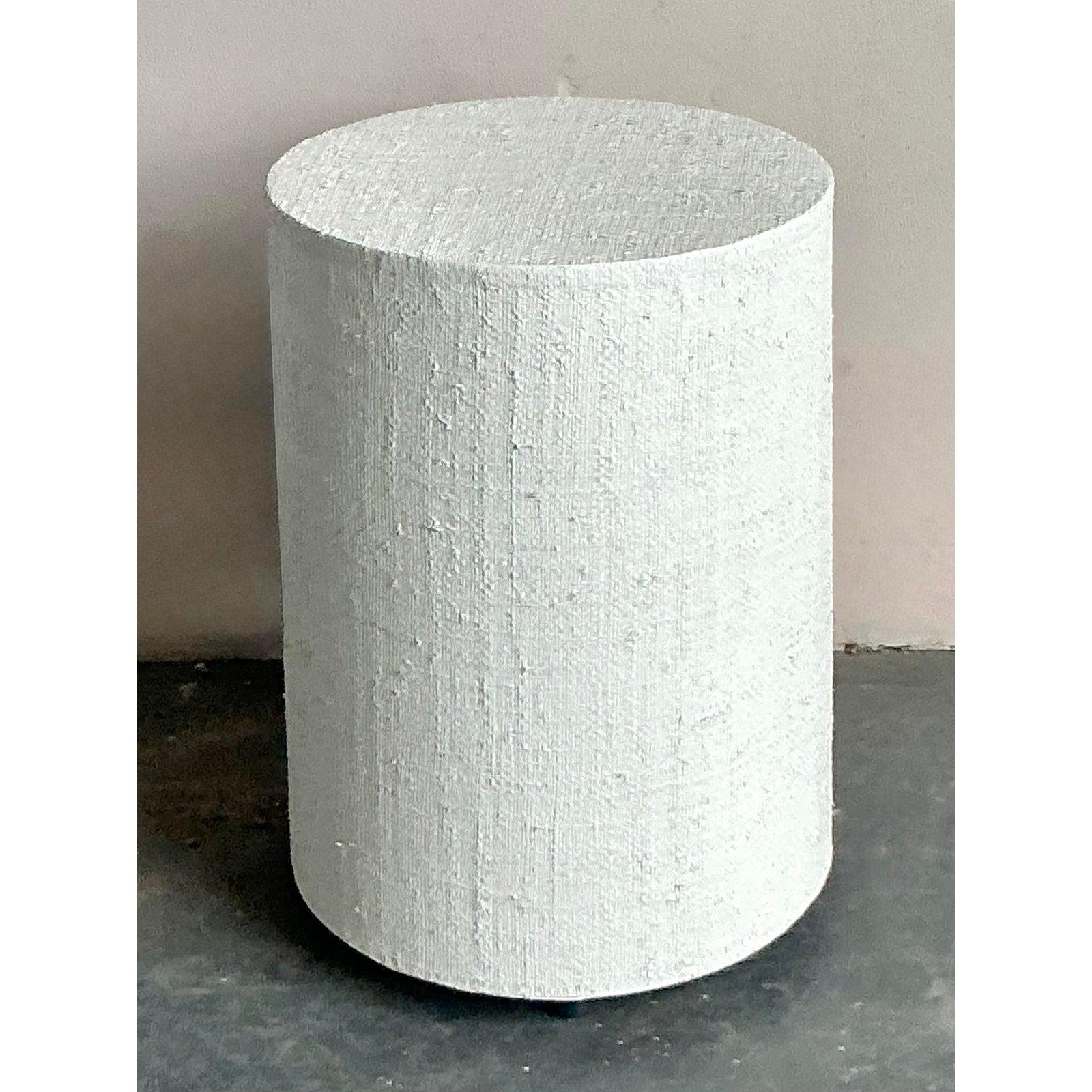 This compelling vintage drum table embodies the relaxed elegance of Organic Modern and Boho Chic design, offering a textural counterpoint to streamlined contemporary furnishings. Dating likely from the 1970s or 1980s, the piece features a sturdy