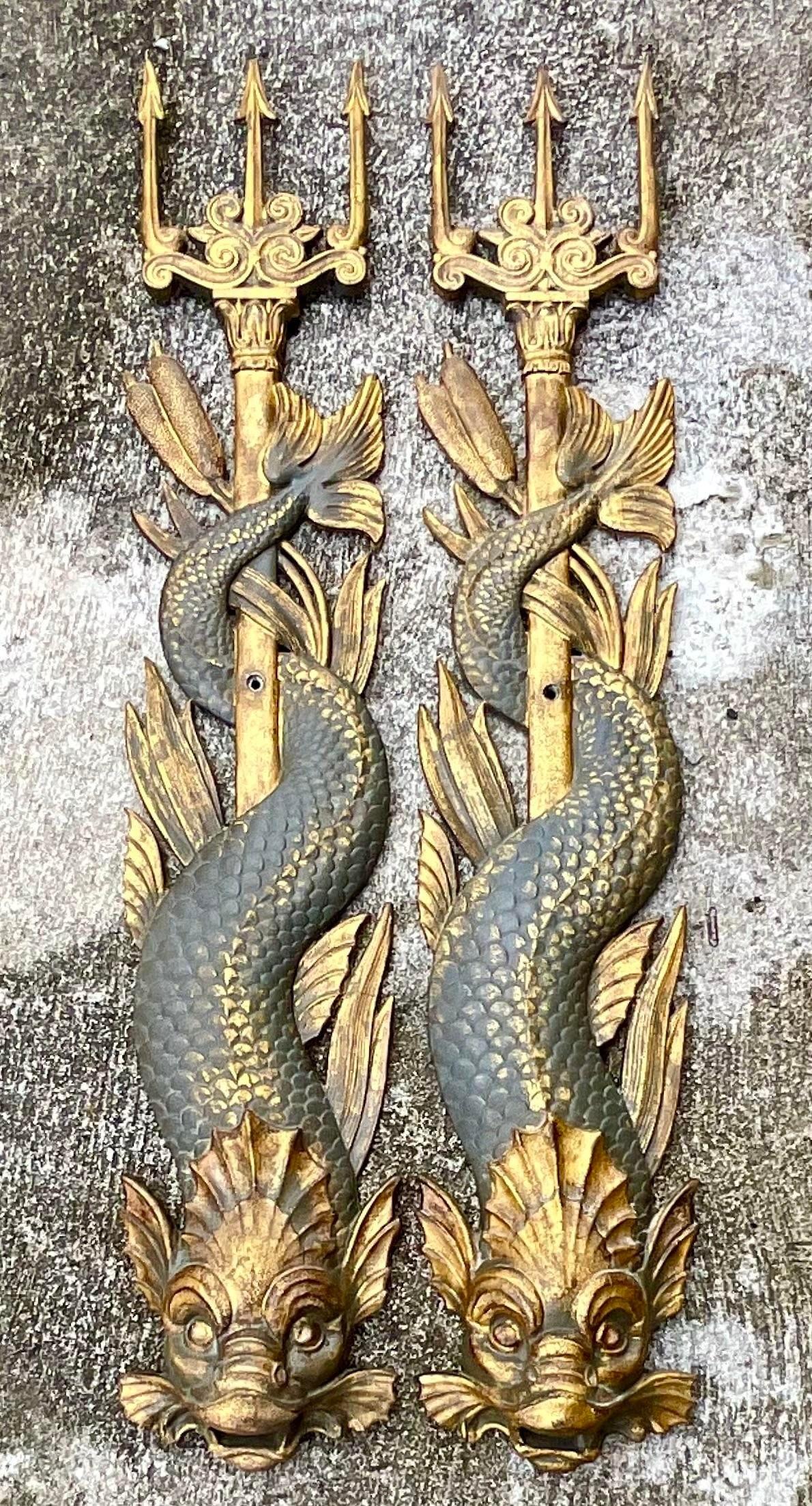 A stunning pair of vintage Boho wall spouts. Cast metal with a hand painted gilt finish. A chic pair of serpent fish wrapped around a trident. Incredible attention to detail. Acquired from a Palm Beach estate.