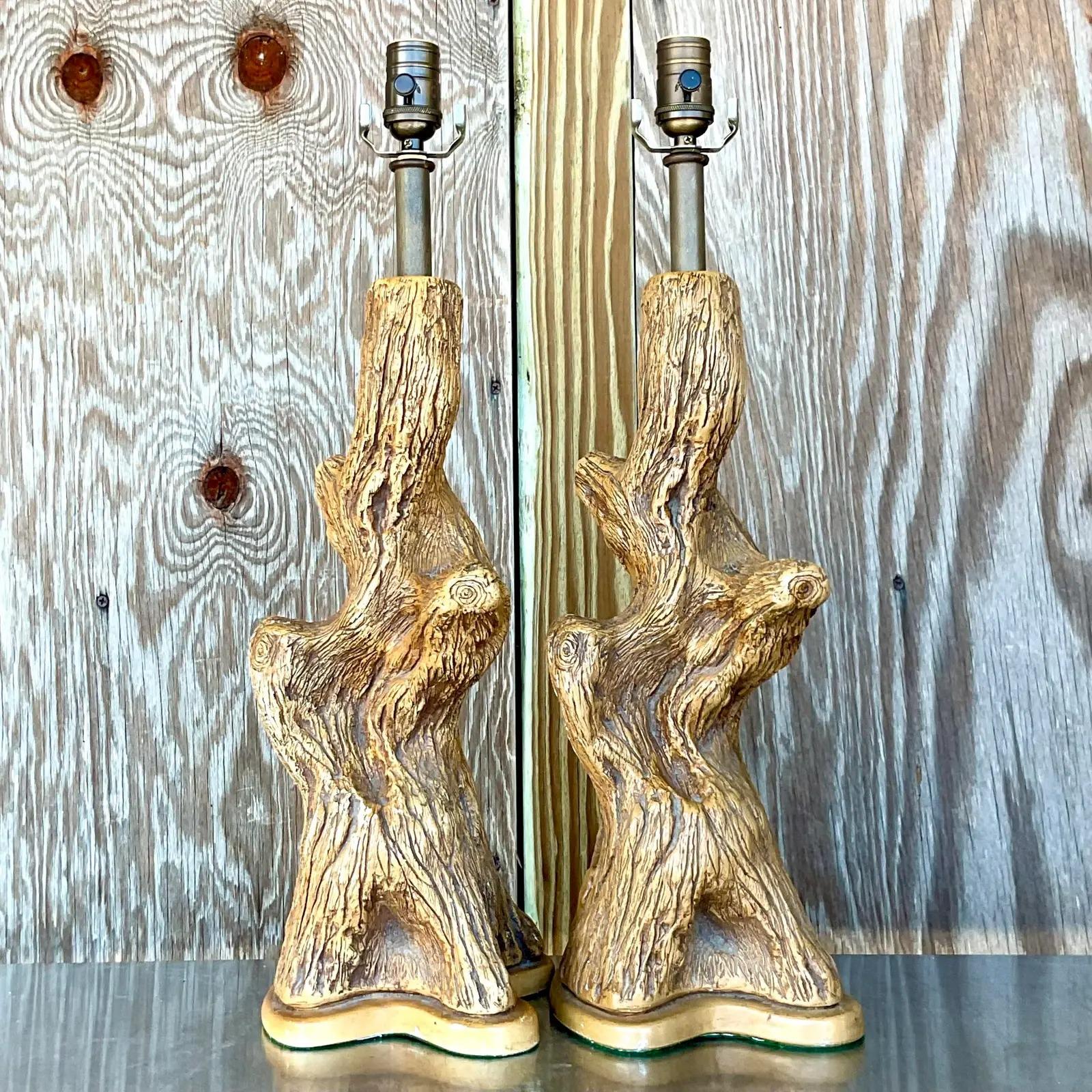 Incredible vintage pair of Boho table lamps. Fantastic tree trunks in a painted plaster body. Fully restored with all new hardware and wiring. Acquired from a Palm Beach estate.