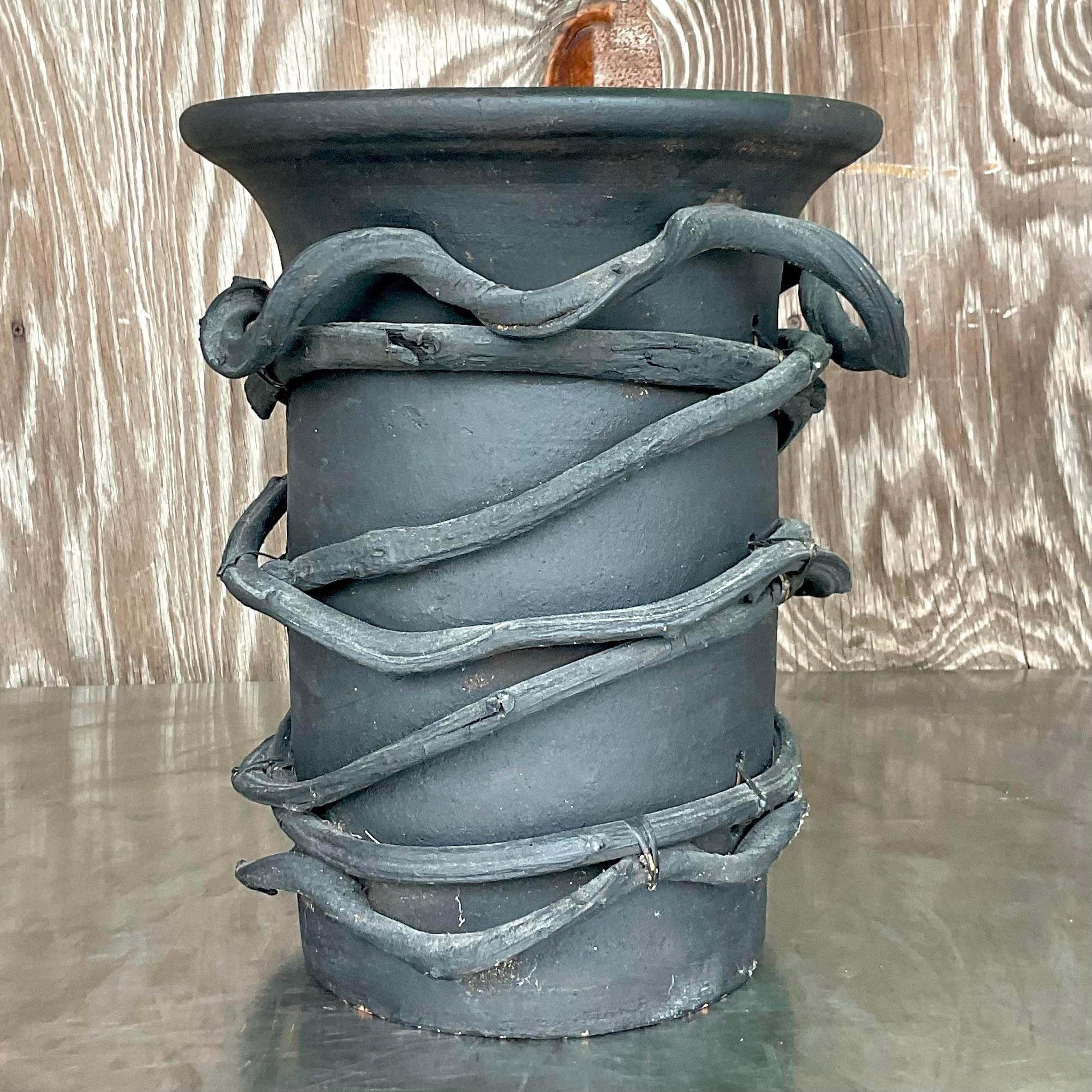 A fantastic vintage Boho vase. A chic hand made studio pottery vase wrapped in a heavy grape vine. Both are roughly painted black for a dramatic effect. Acquired from a Palm Beach estate.