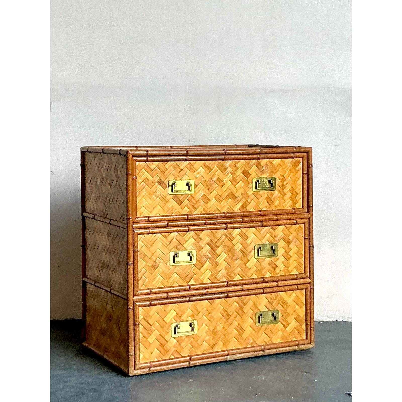 Introduce a touch of exotic sophistication to your interior with this captivating vintage three-drawer chest, artfully crafted from rattan with a unique parquet pattern. This piece exudes a distinct Boho Chic aesthetic, blending natural textures