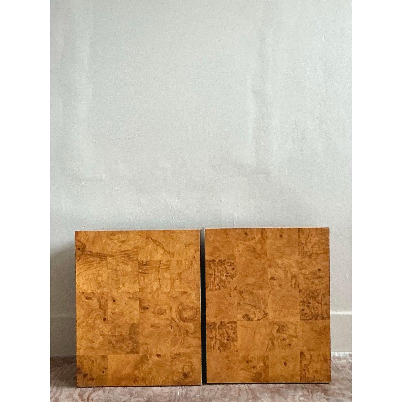 A pure expression of 1970s glamour, this iconic pair of patchwork pedestals brings incredible texture and visual interest to any interior. Each cube is meticulously wrapped in tessellated squares of highly figured burl wood, creating a rich tapestry