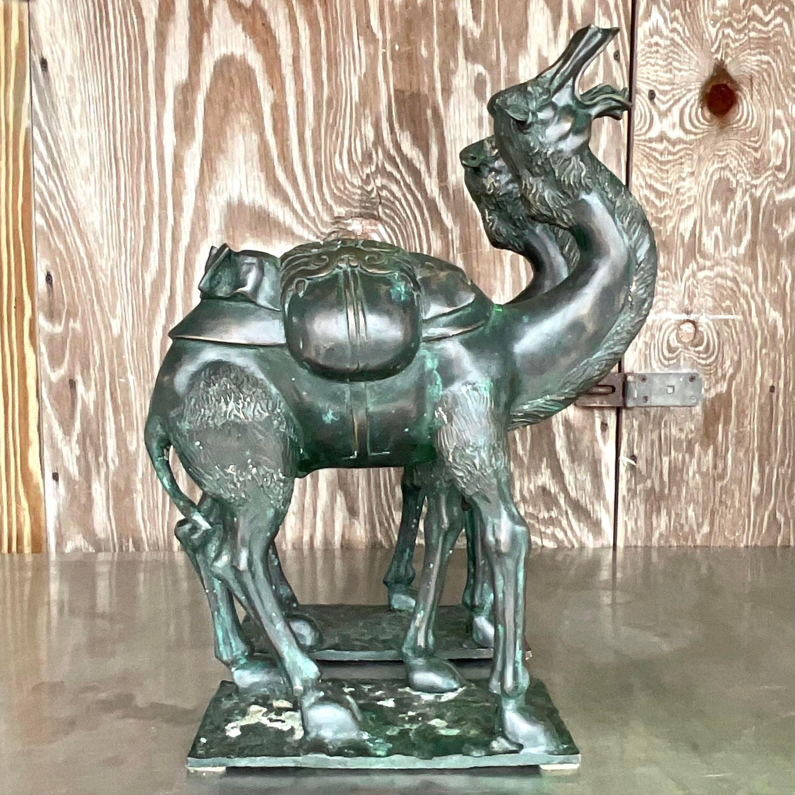 A stunning pair of vintage Boho camels. A chic bronze construction with a beautiful patina from time. Monumental in size and drama. Acquired from a Palm Beach estate. 