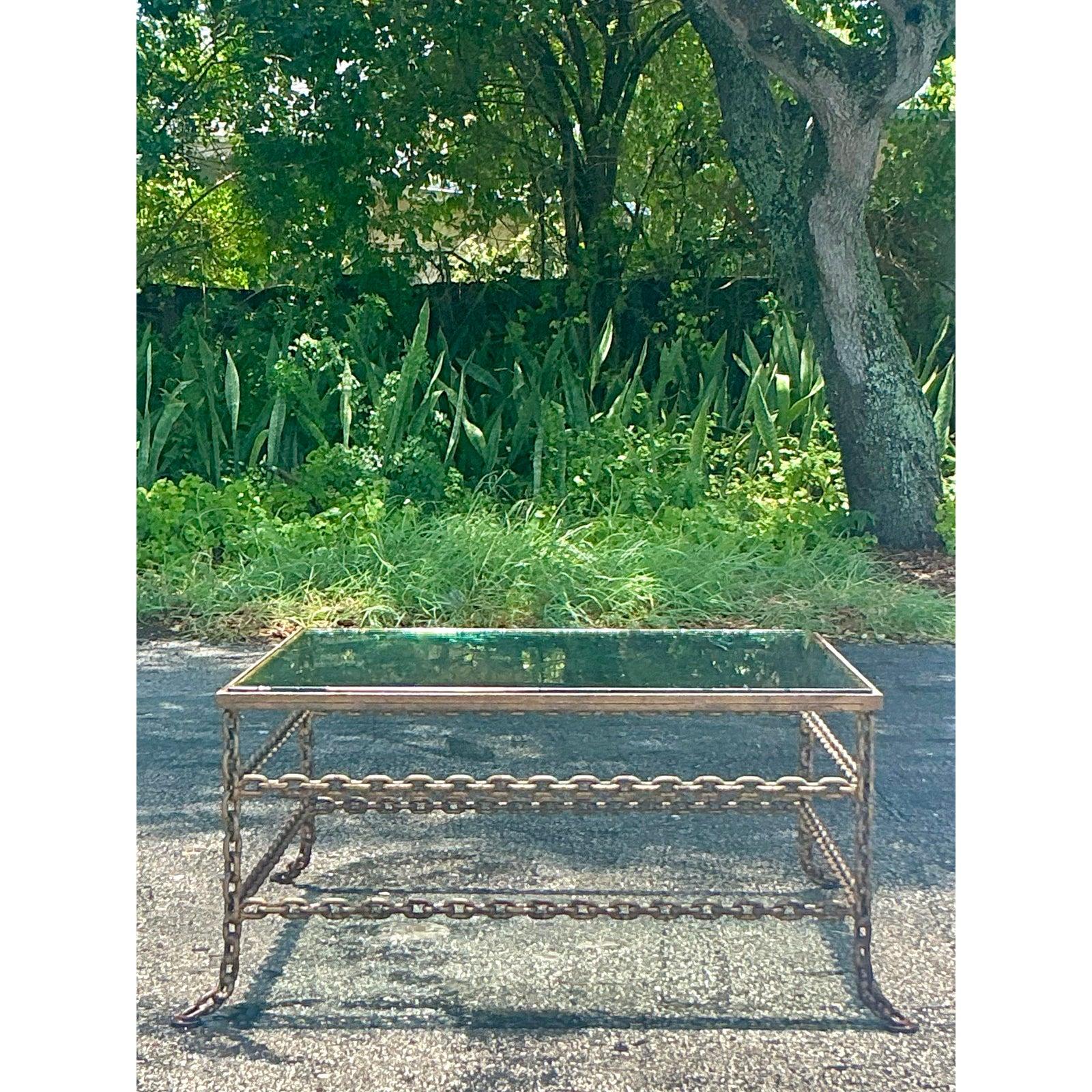 Anchor your living space with the raw power and sculptural artistry of this incredible vintage chain link coffee table. Masterfully constructed from heavy-gauge welded steel chain, this table is a testament to bold, industrial design. The intricate,