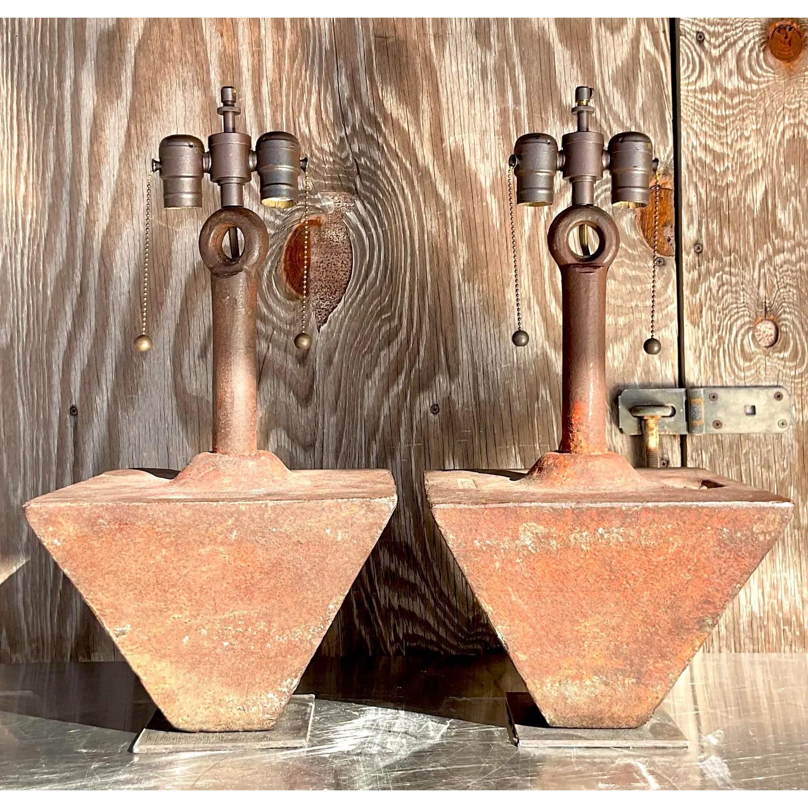 An incredible pair of vintage Boho Lamps. Awesome rusty iron boat 75lb weights. A chic pyramid shapes and marked 75. Acquired from a Newport estate designed by the celebrated designer James Huniford.