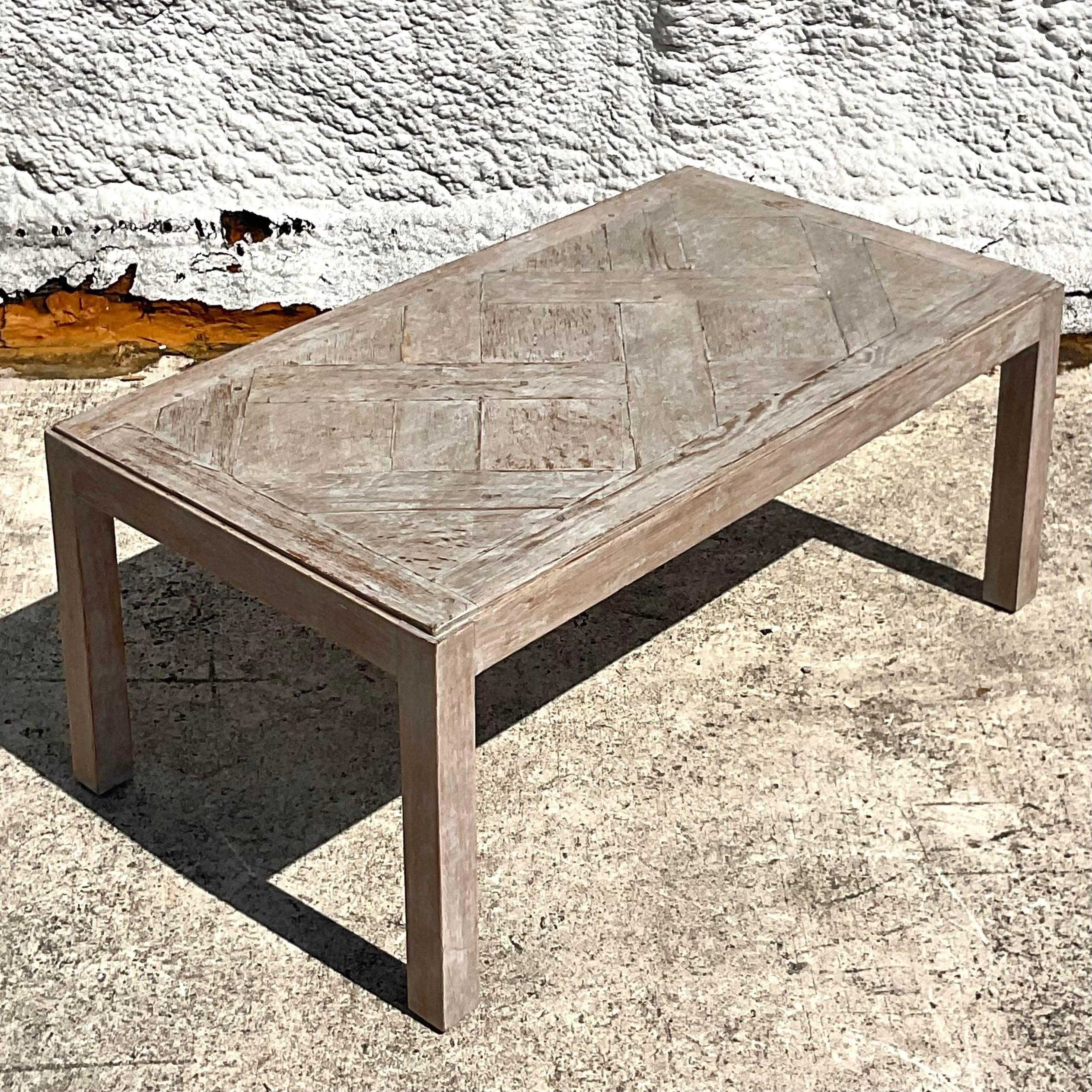 This vintage Boho coffee table features a patinated lattice design, adding a touch of rustic charm and eclectic style to your living space