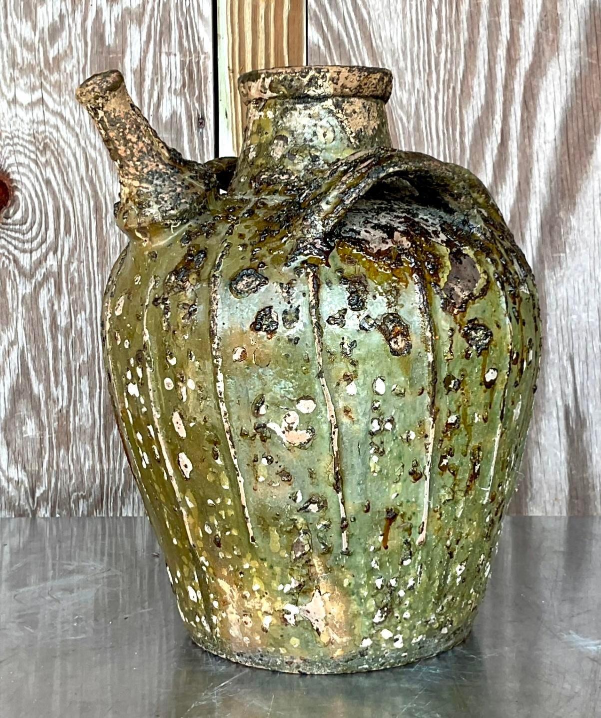 Earthen Elegance: The Vintage Boho Patinated Matte Glazed Ceramic Urn exudes American style with its rustic allure and timeless sophistication. Crafted with meticulous detail, its patinated finish adds a touch of vintage charm, while the matte glaze