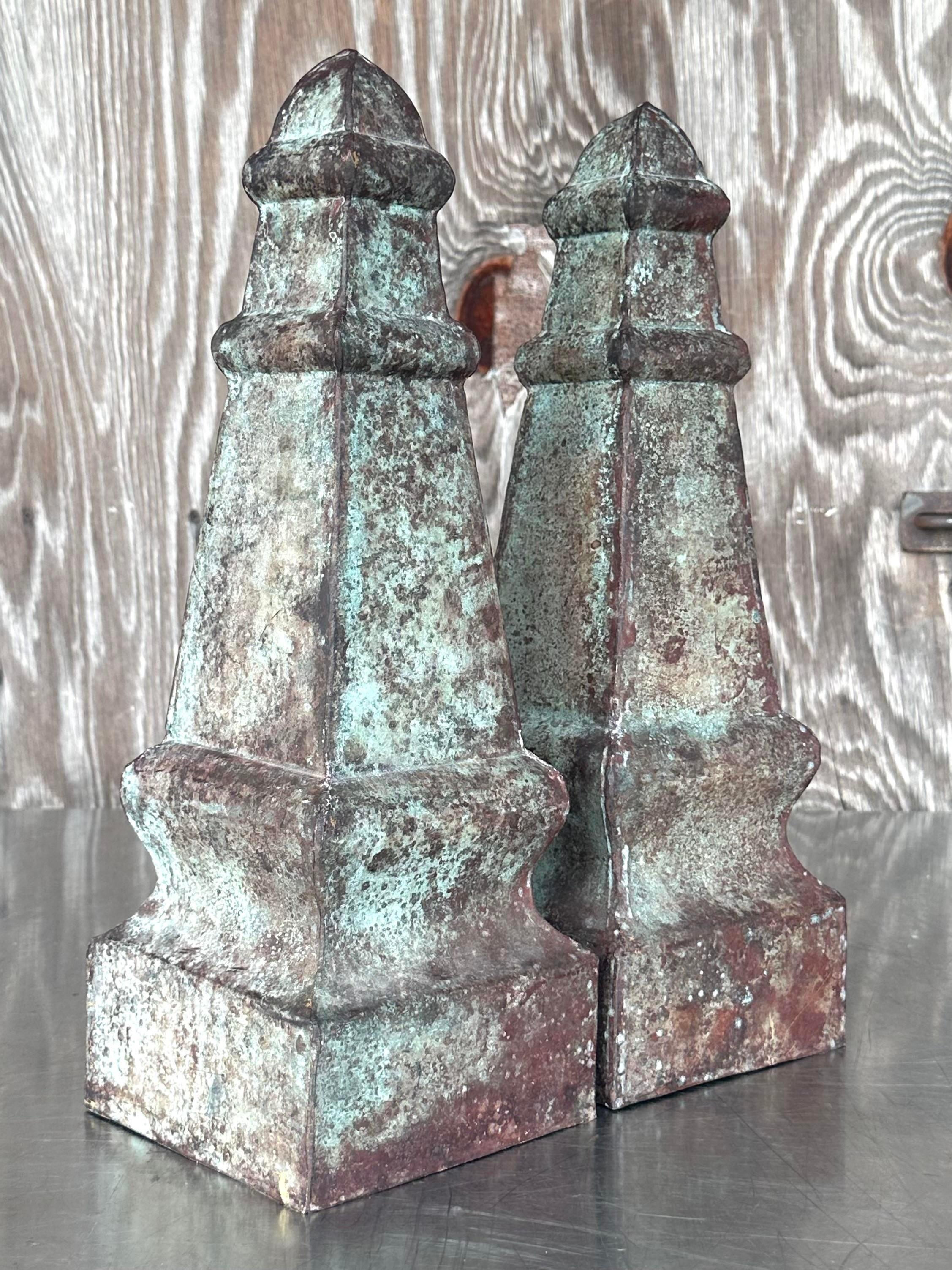 A stunning pair of vintage Boho obelisks. A gorgeous all over patina from time give them the most amazing finish. Acquired from a Palm Beach estate.