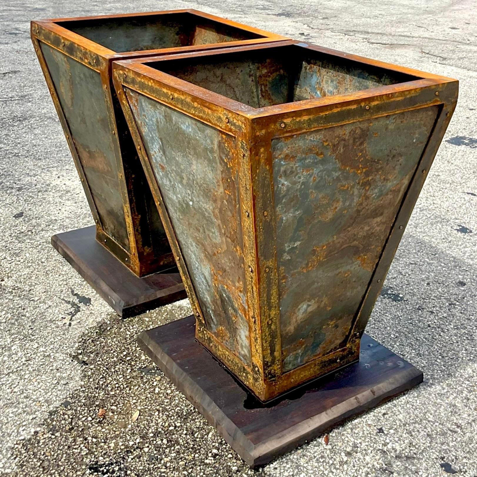 A stunning pair of vintage Boho planters. The most incredible all over patinated finish. Thr planters rest on wooden plinths. Acquired from a Palm Beach estate.