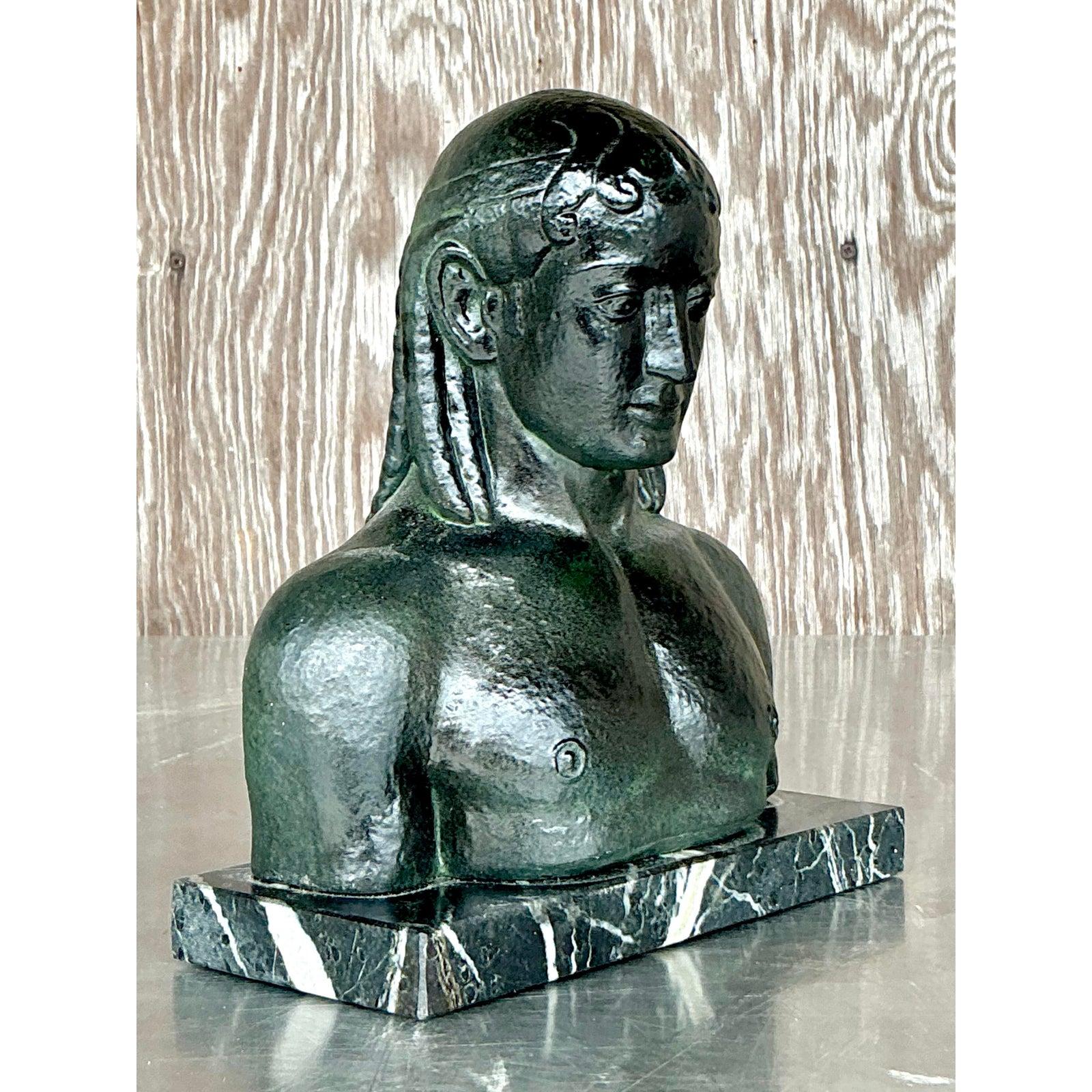 Infuse your interior with a sense of timeless artistry and enigmatic charm with this vintage patinated plaster bust of a man. The figure's strong, stylized features and rich, dark patina evoke a classical sensibility with a distinct, almost tribal