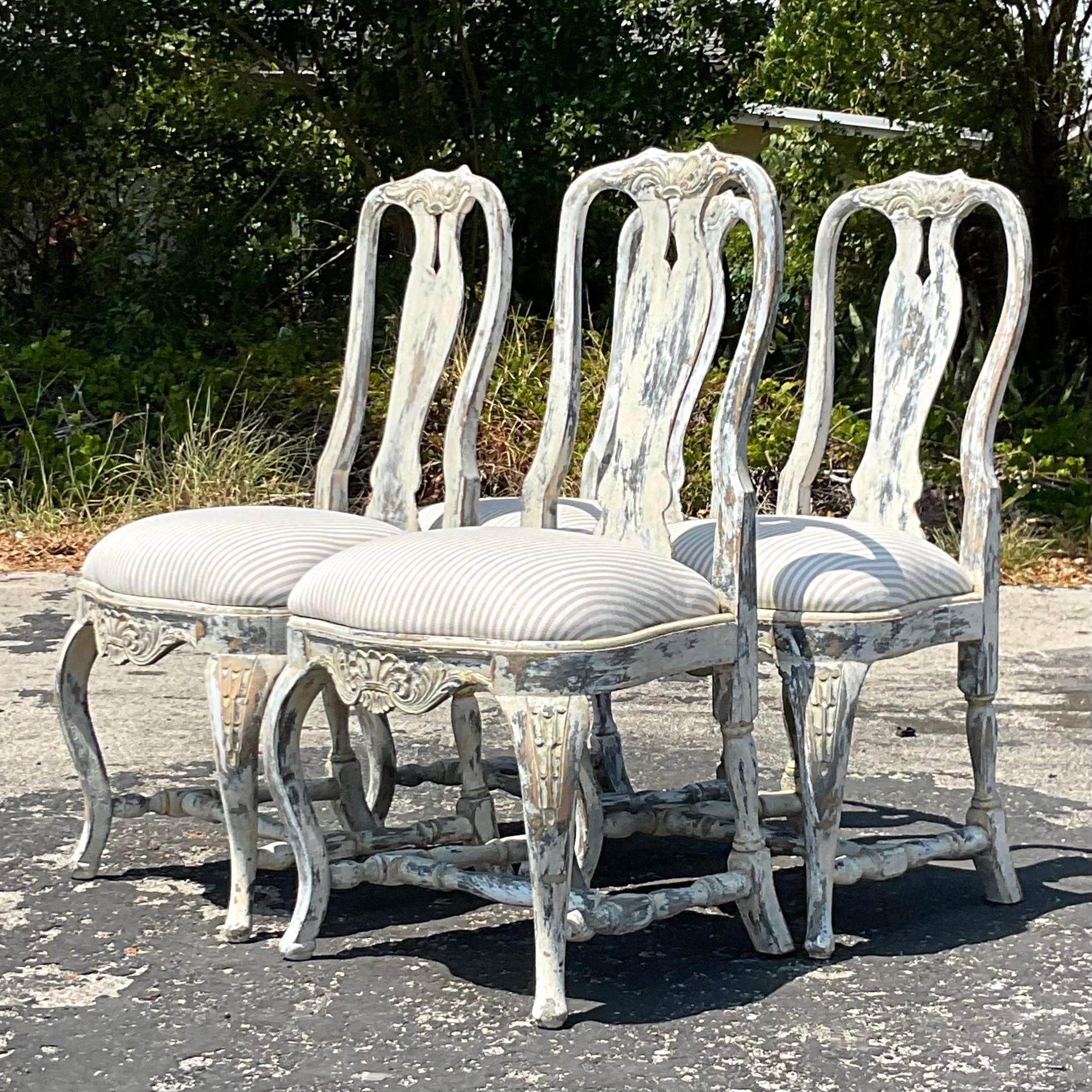 A stunning set of four vintage Boho dining chairs. A chic Queen Ann style with a contemporary patinated finish. Newly reupholstered in a striped neutral. Acquired from a Palm Beach estate.
