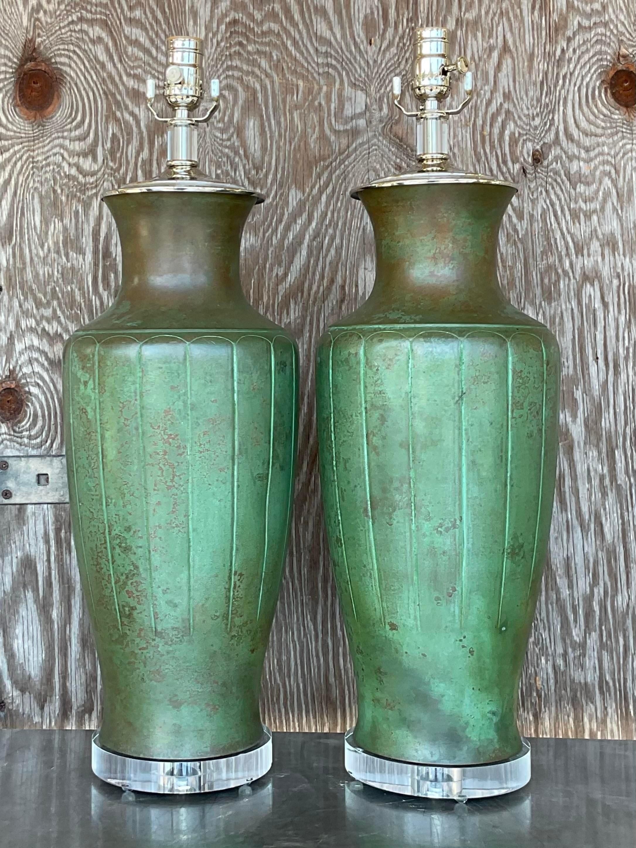 A fabulous pair of vintage green table lamps with clear lucite block bases. They have a chic patinated finish to them. Fully restored with all new wiring, hardware and lucite plinth. Acquired at a Palm Beach estate.