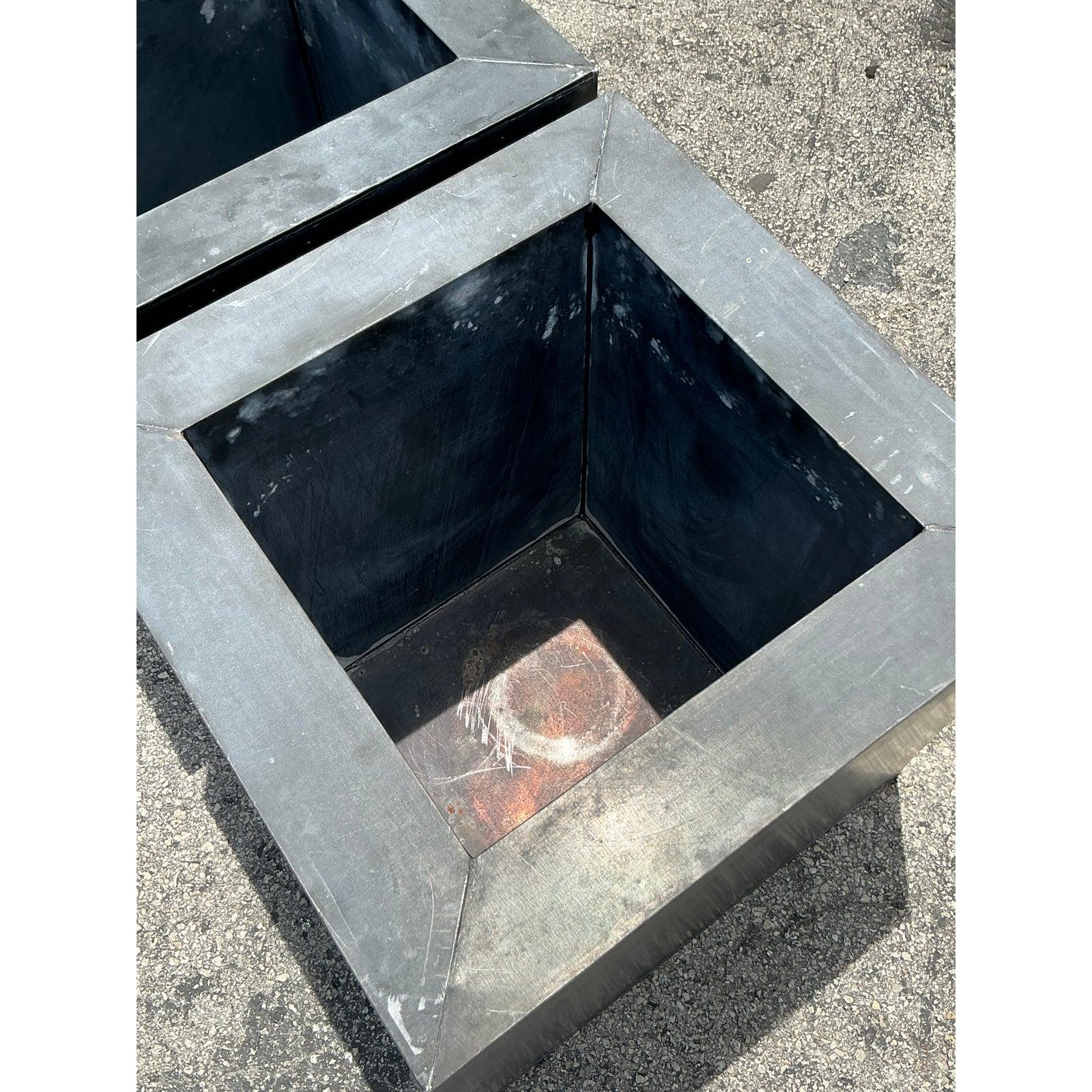 Elevate your indoor or outdoor oasis with this striking Pair of Vintage Industrial Patinated Square Tin Planters, a truly unique find that marries rugged durability with sophisticated design. Each planter boasts a clean-lined, architectural cube