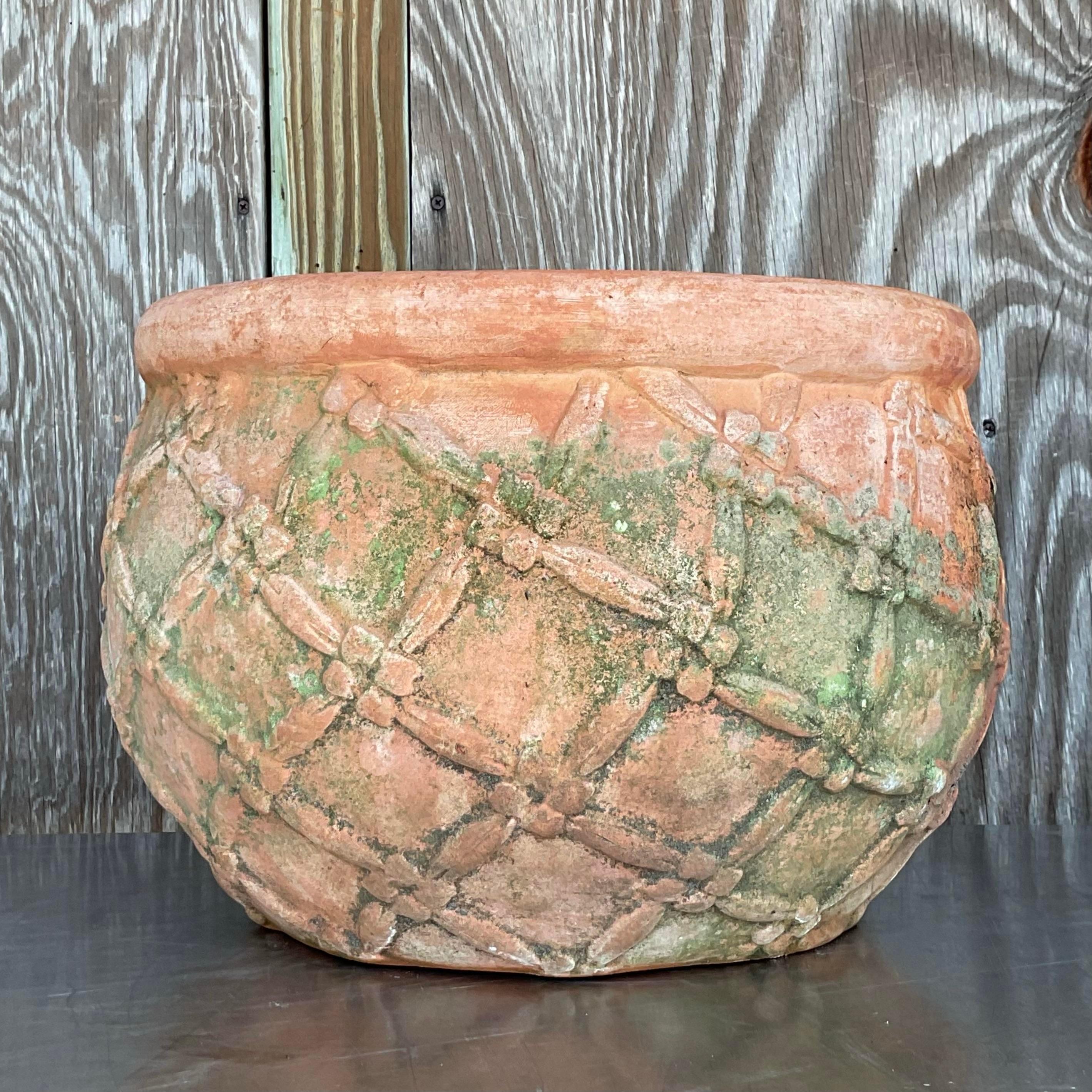Vintage Boho Patinated Trellis Terracotta Planter, showcasing a weathered finish and trellis design. A charming, rustic piece perfect for adding bohemian flair to your garden or patio. Acquired from a Palm Beach estate.