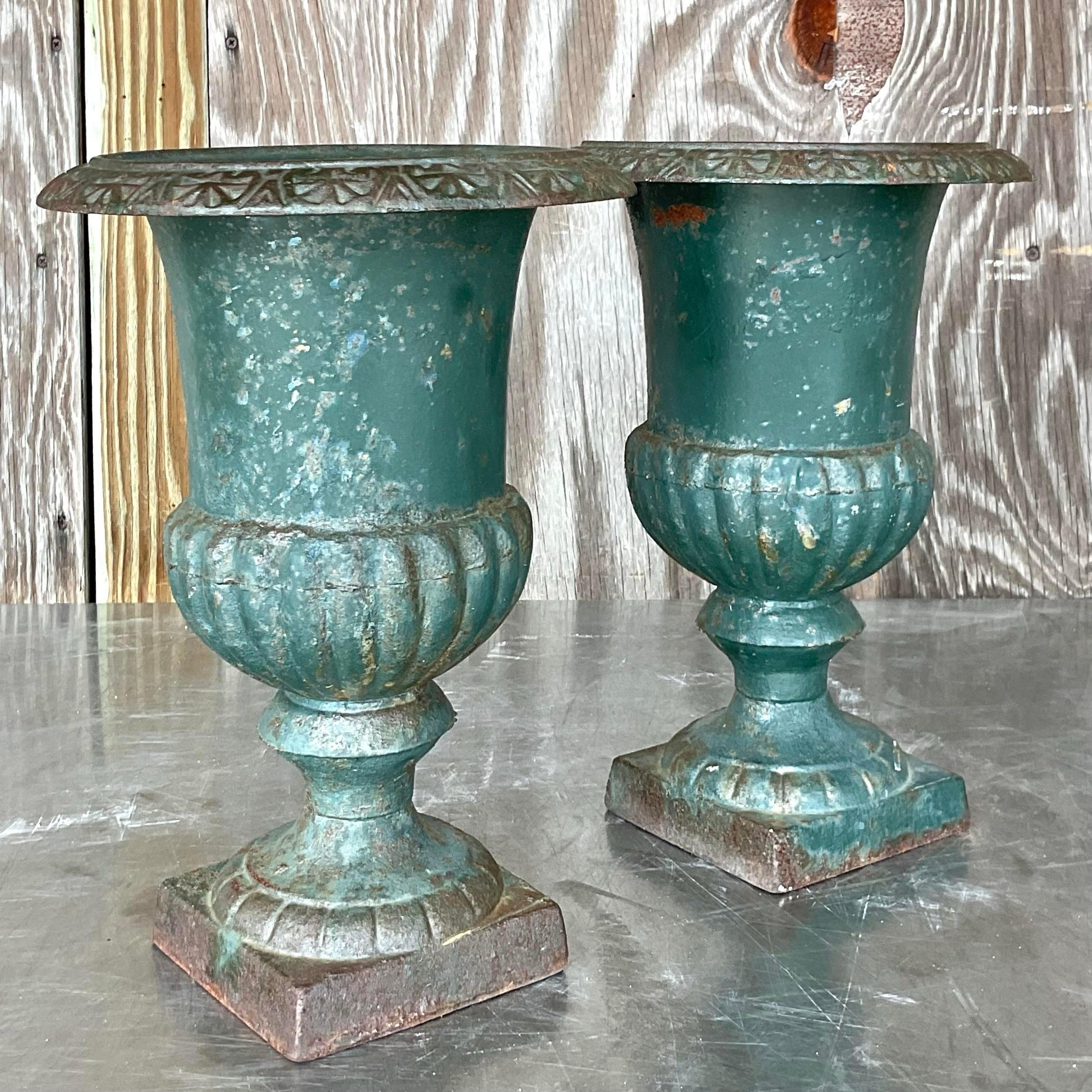 Enhance your décor with a touch of timeless Americana charm! This pair of vintage boho patinated wrought iron urns exudes rustic elegance, perfect for adding character to any space. Embrace the heritage and craftsmanship of yesteryears with these