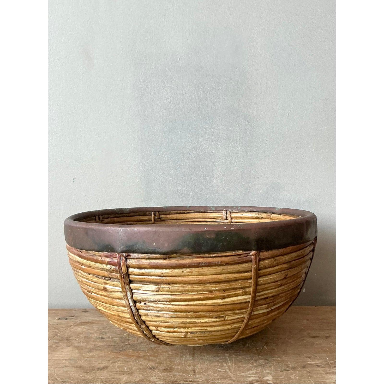 Ce bol vintage exceptionnellement travaillé est un exemple remarquable de design côtier texturé, utilisant des matériaux naturels de manière sophistiquée. Le corps est formé d'anneaux concentriques de roseau de crayon élancé, offrant une surface
