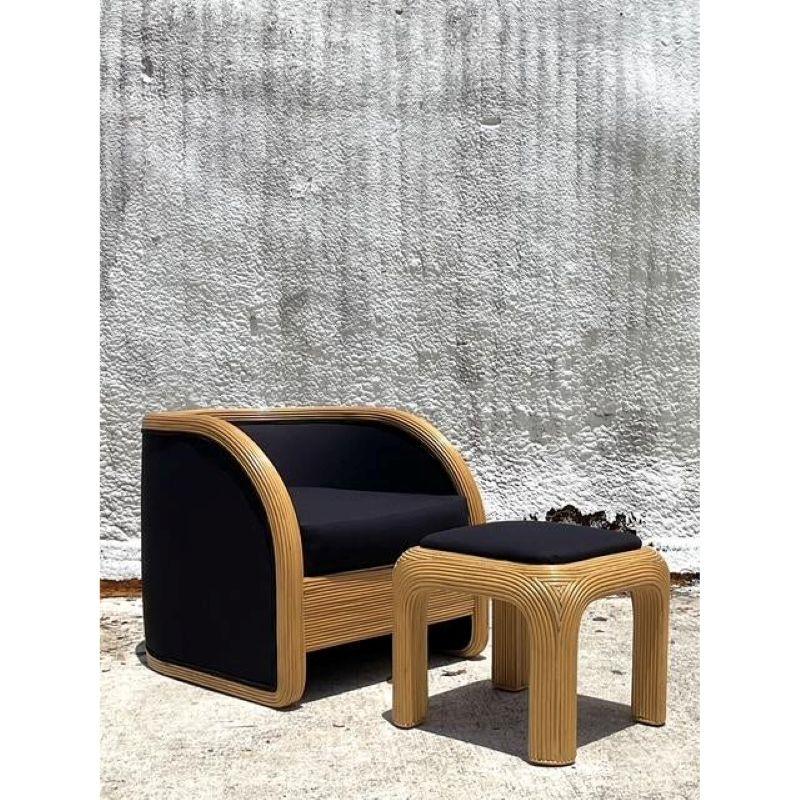 Experience the perfect marriage of organic texture and glamorous form with this vintage pencil reed lounge chair. A testament to 1980s design innovation, the chair's iconic waterfall frame is masterfully wrapped in bundled rattan, creating a