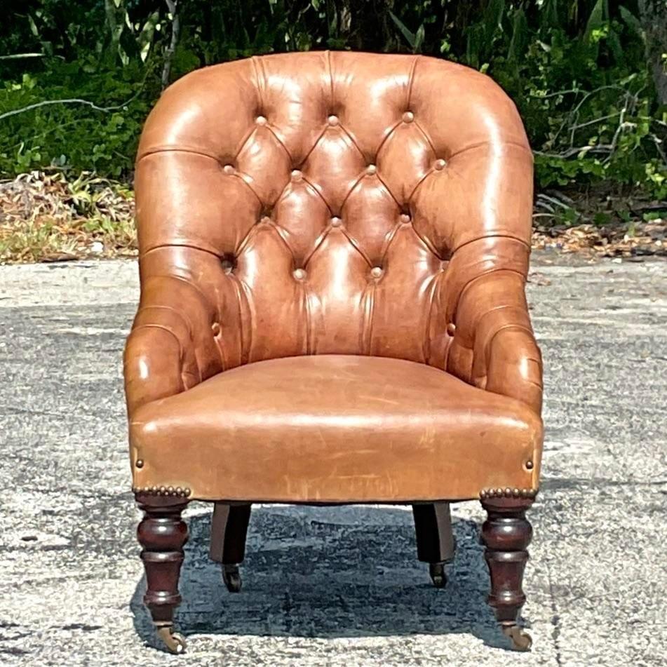 A stunning vintage Boho petite Chesterfield fireside chair. Beautiful tufted leather with chic nailhead trim. Acquired from a Palm Beach estate.