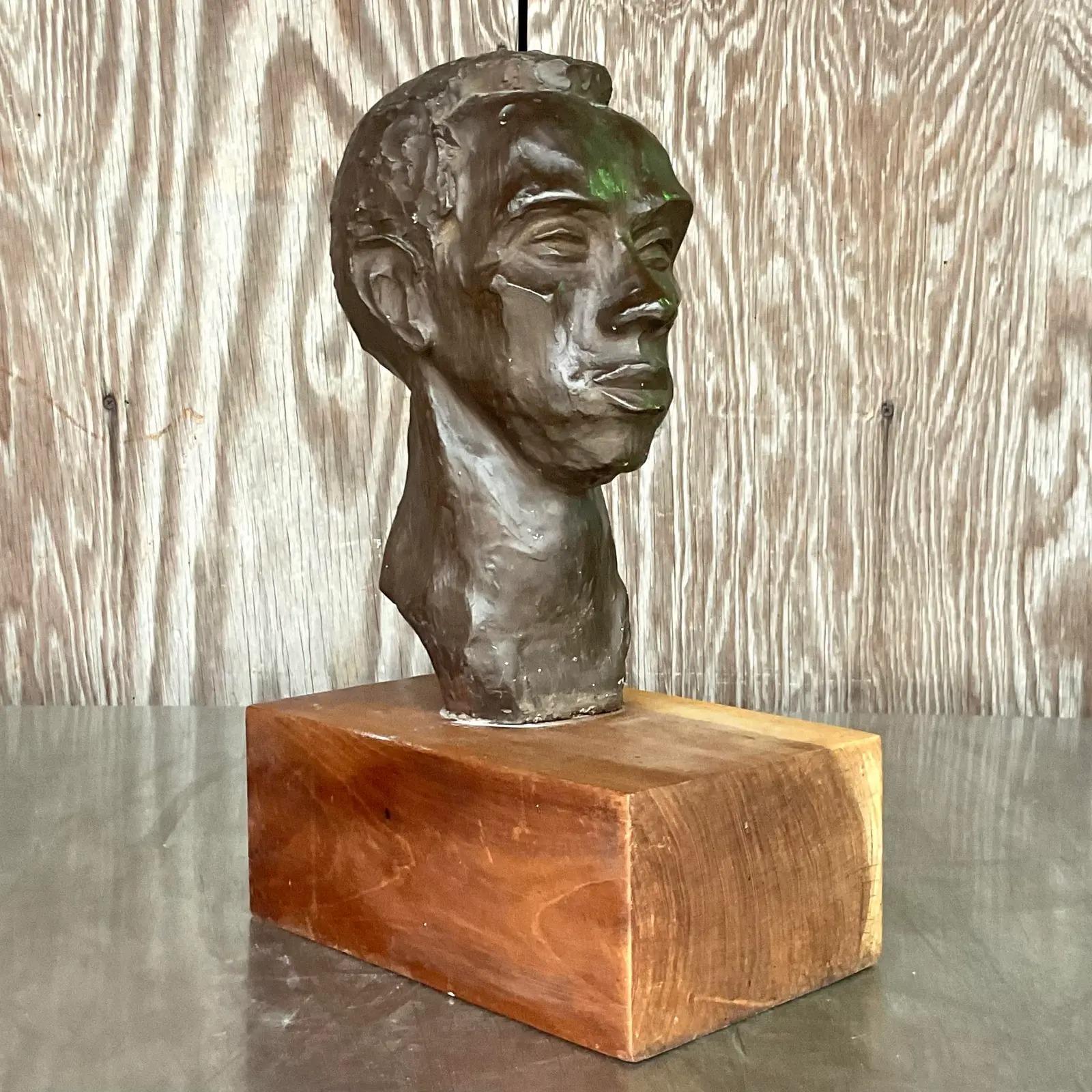 A brilliant vintage Boho sculpture. An amazing plaster composition with beautiful attention to detail. Rests on a wood plinth. Signed on the bottom. Acquired from a Palm Beach estate.