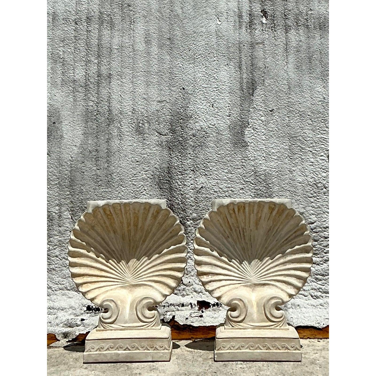 Immerse your space in timeless elegance with this exquisite pair of Vintage Boho Plaster Clamshell Dining Table Pedestals. Each pedestal is meticulously crafted to evoke the natural beauty of a majestic seashell, offering a unique blend of coastal