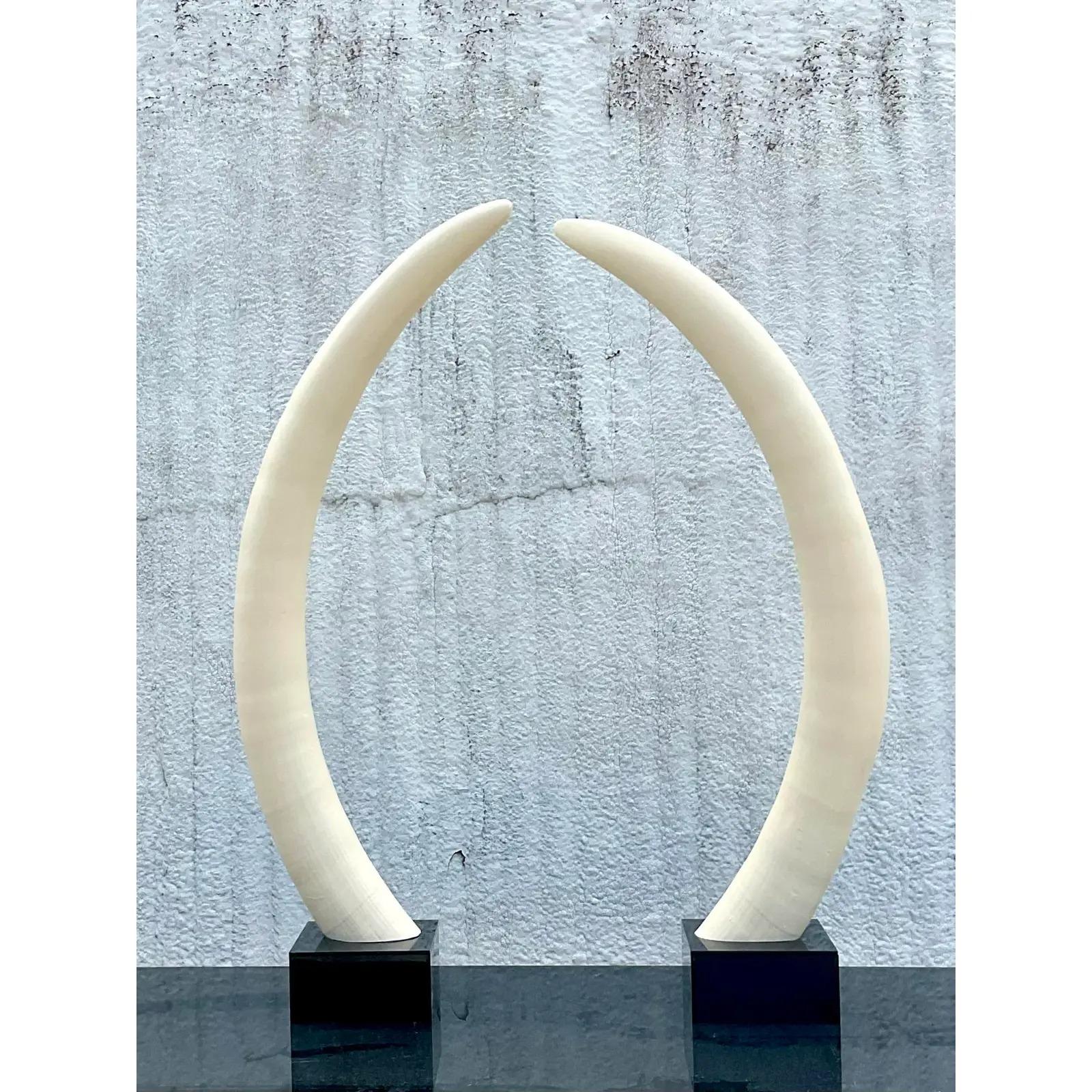 Fantastic pair of vintage Boho elephant tusks. Made from a plaster over resin and resting on plexi plinths. Acquired from a Palm Beach estate.