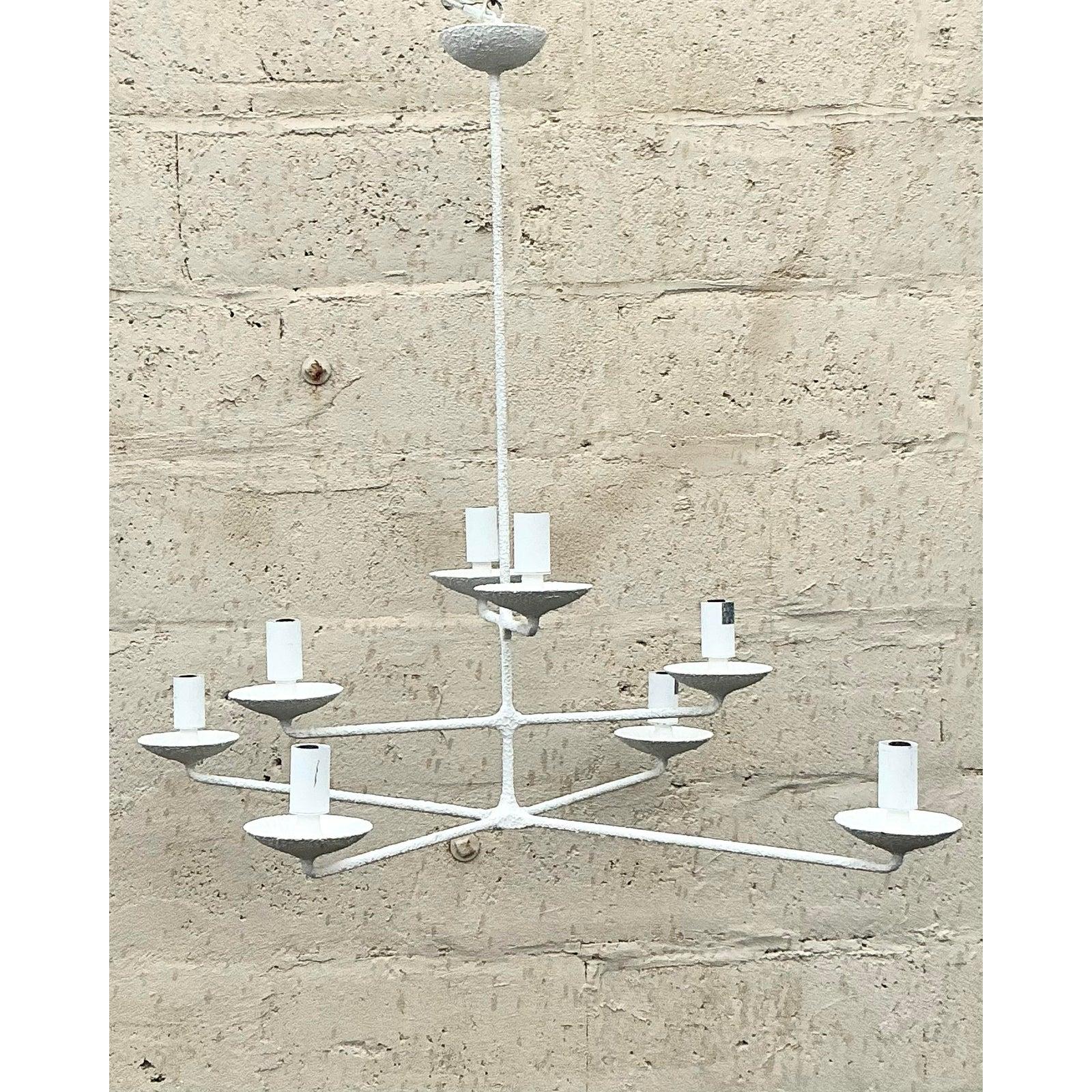 Illuminate your space with the distinctive artisanal charm of this vintage tri-level chandelier. Its captivating sculptural form, featuring three gracefully staggered tiers of arms, is entirely enveloped in a rich, textured white plaster finish,