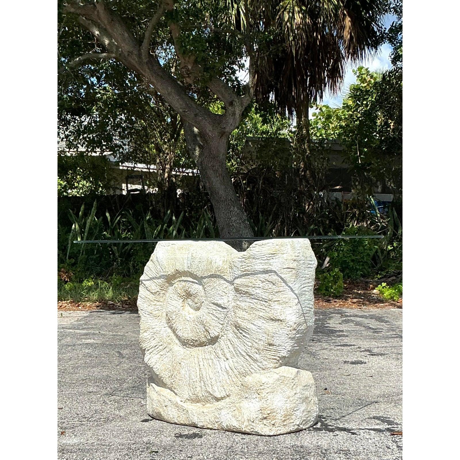 Make a stunning statement with this captivating vintage console table, featuring a dramatic sculptural nautilus shell base! Crafted from plaster (or plaster-finish composite), the base beautifully captures the organic elegance of the nautilus form,