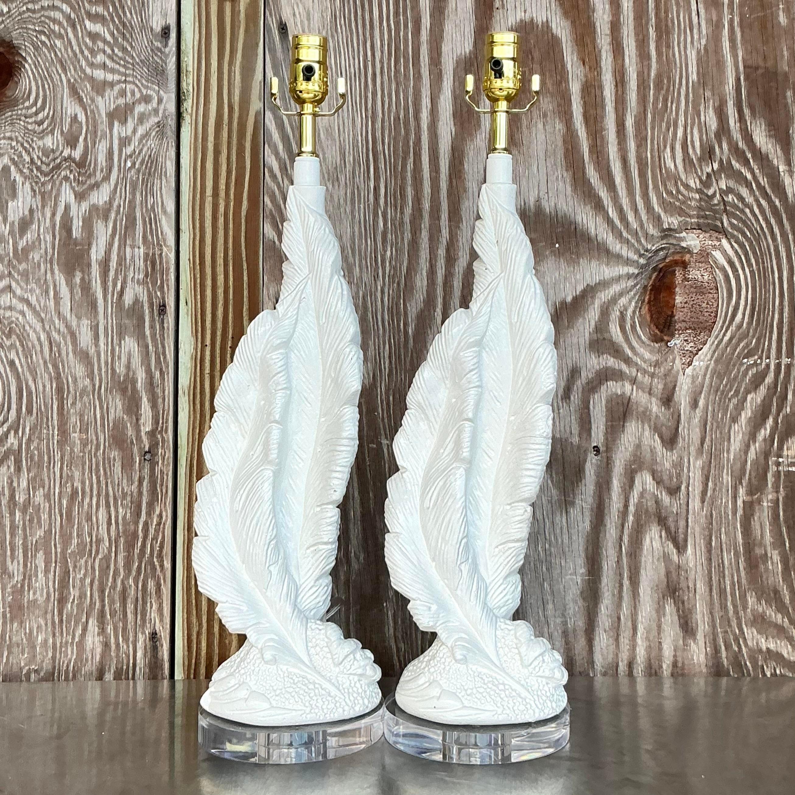 Illuminate your space with this stunning pair of vintage Boho plaster twisted feather lamps. Featuring intricate feather designs and a unique twisted silhouette, these lamps add a touch of artistry and texture to any room. The soft, neutral tones