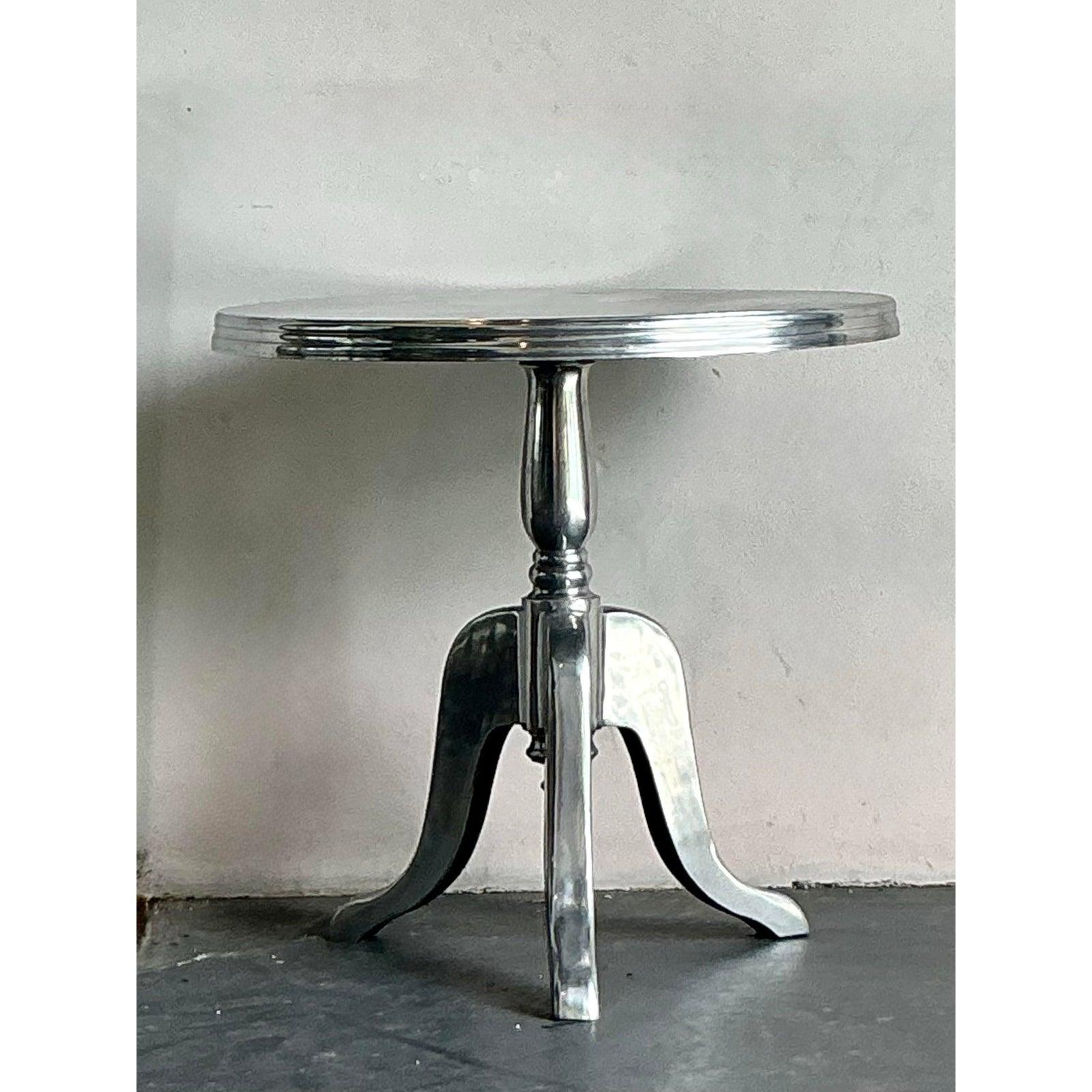 Elevate your living space with this exquisite vintage polished aluminum cafe table, a piece that effortlessly blends bohemian charm with a sleek, contemporary edge. Its radiant finish and sturdy construction make it a versatile addition, perfect for