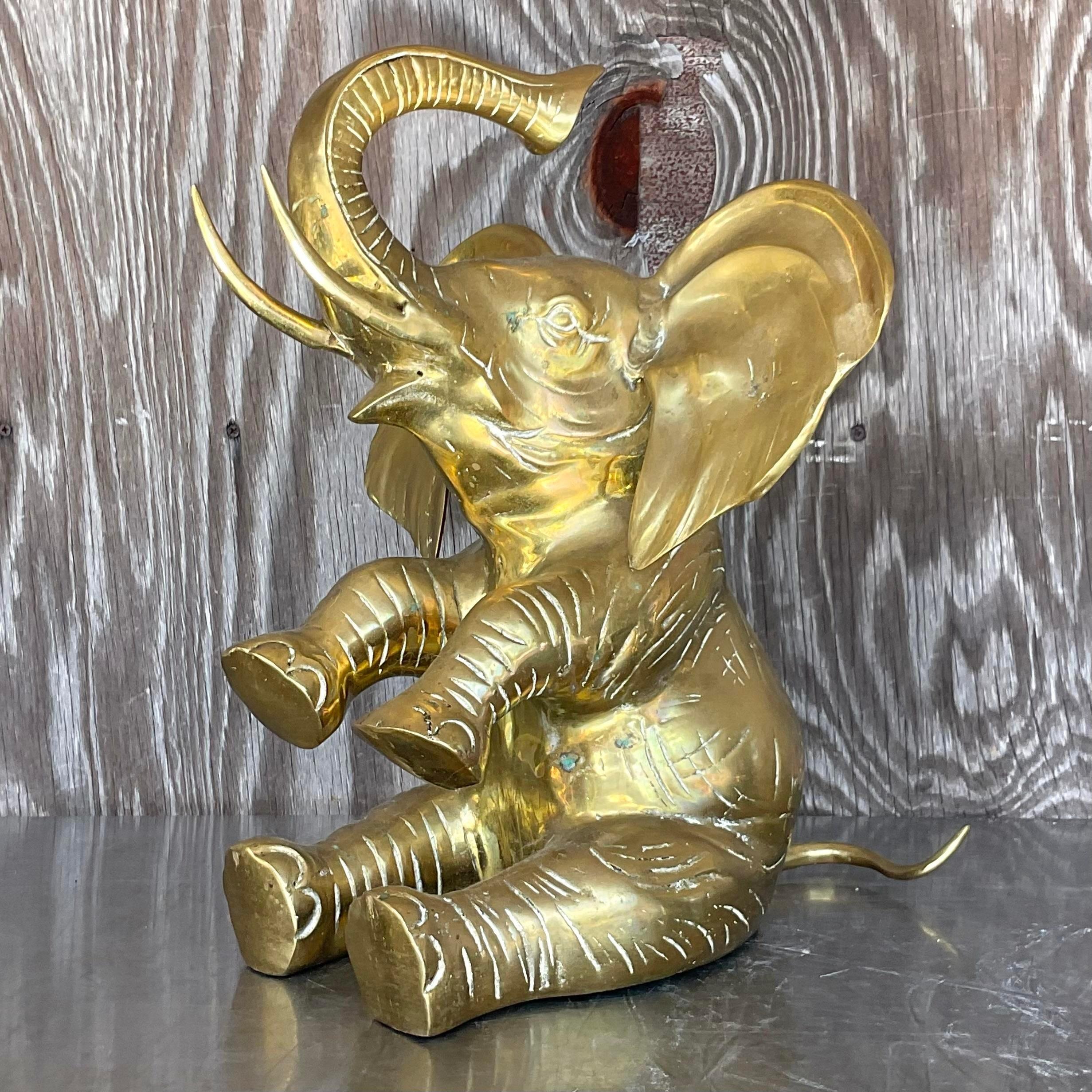A fabulous vintage Boho elephant. A chic polished brass figure in a terrific pose. Trunk in the air for good luck. Acquired from a Palm Beach estate.