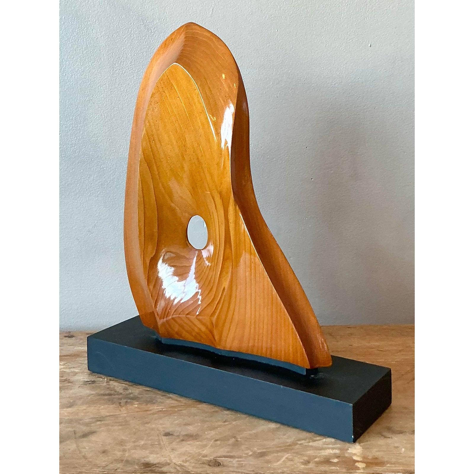 Scopri questa affascinante scultura astratta vintage, testimonianza dell'estetica moderna e organica dell'epoca. Realizzato in legno splendidamente lucidato, questo pezzo presenta curve sensuali e una venatura naturale che attira lo sguardo,