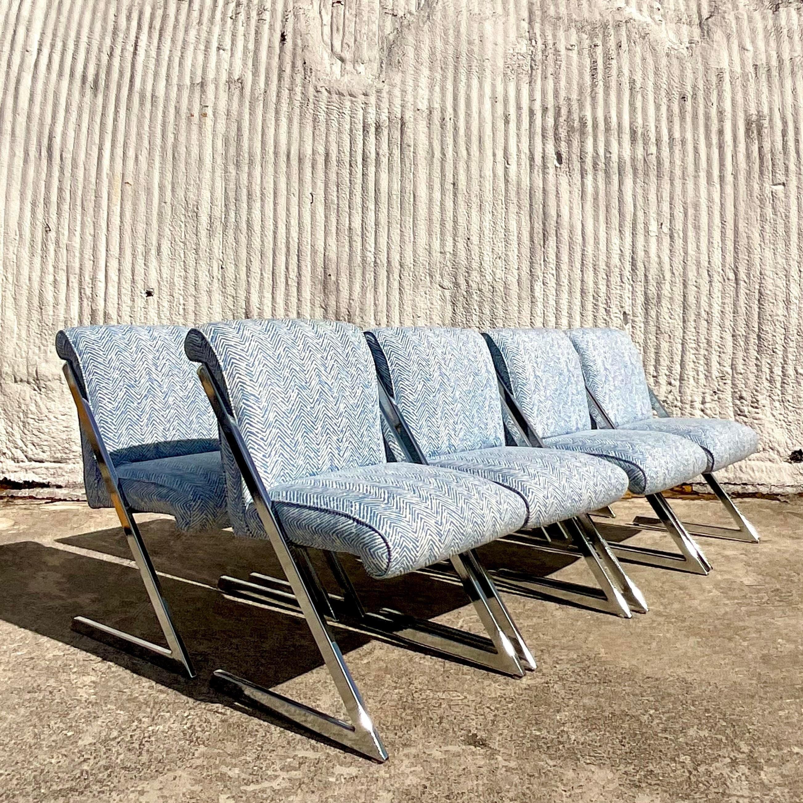 A spectacular set of vintage Boho pristine dining chairs. The iconic Z chair in polished chrome in the manner of Milo Baughman. Freshly reupholstered in Meg Braff Tweed collection fabric in Medium blue. Acquired from a Palm Beach estate.