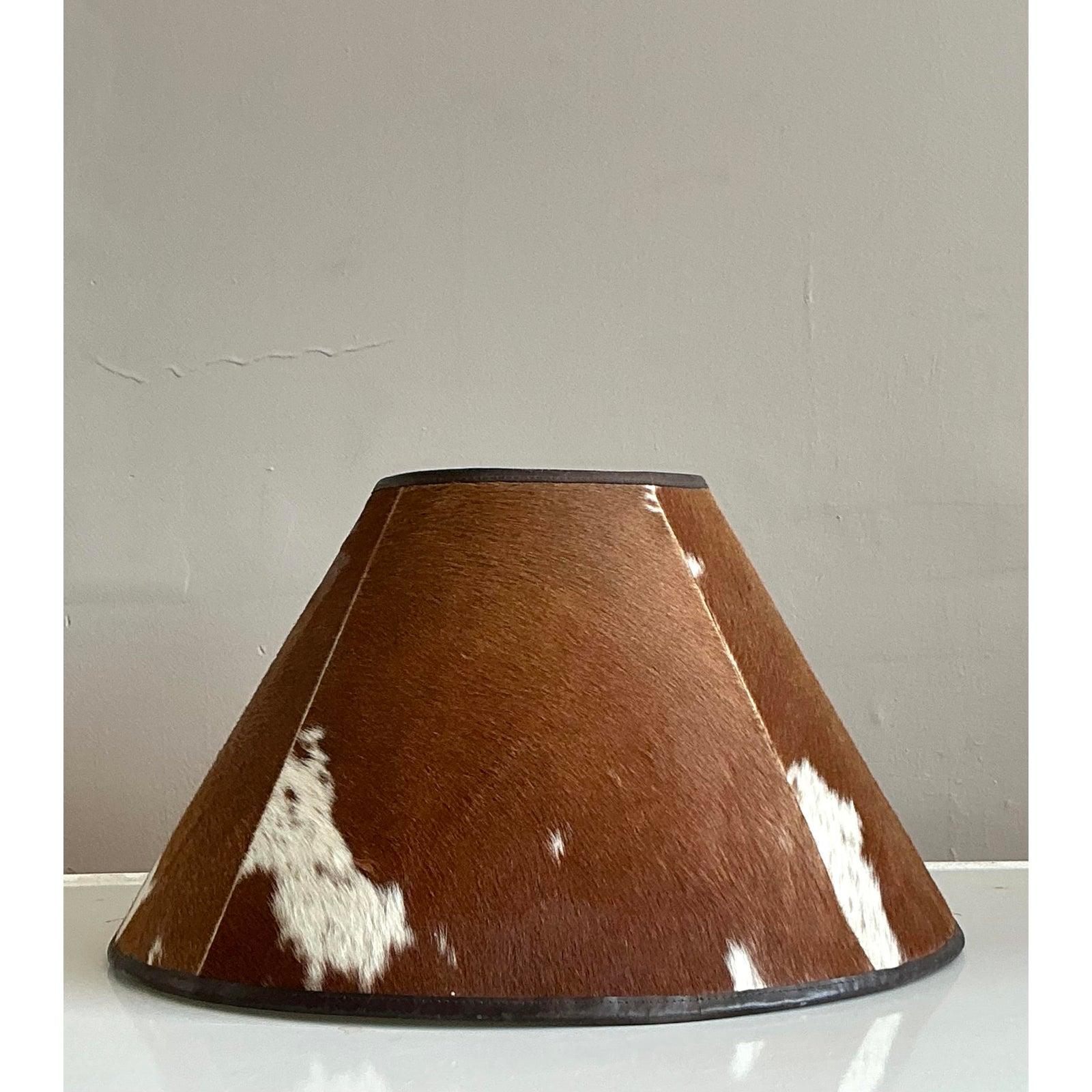 Introduce a dramatic layer of organic texture and rustic charm to your interior with this incredible vintage pony hair lampshade. Crafted from genuine brown and white hide, this piece offers a tactile and visual warmth that is both sophisticated and
