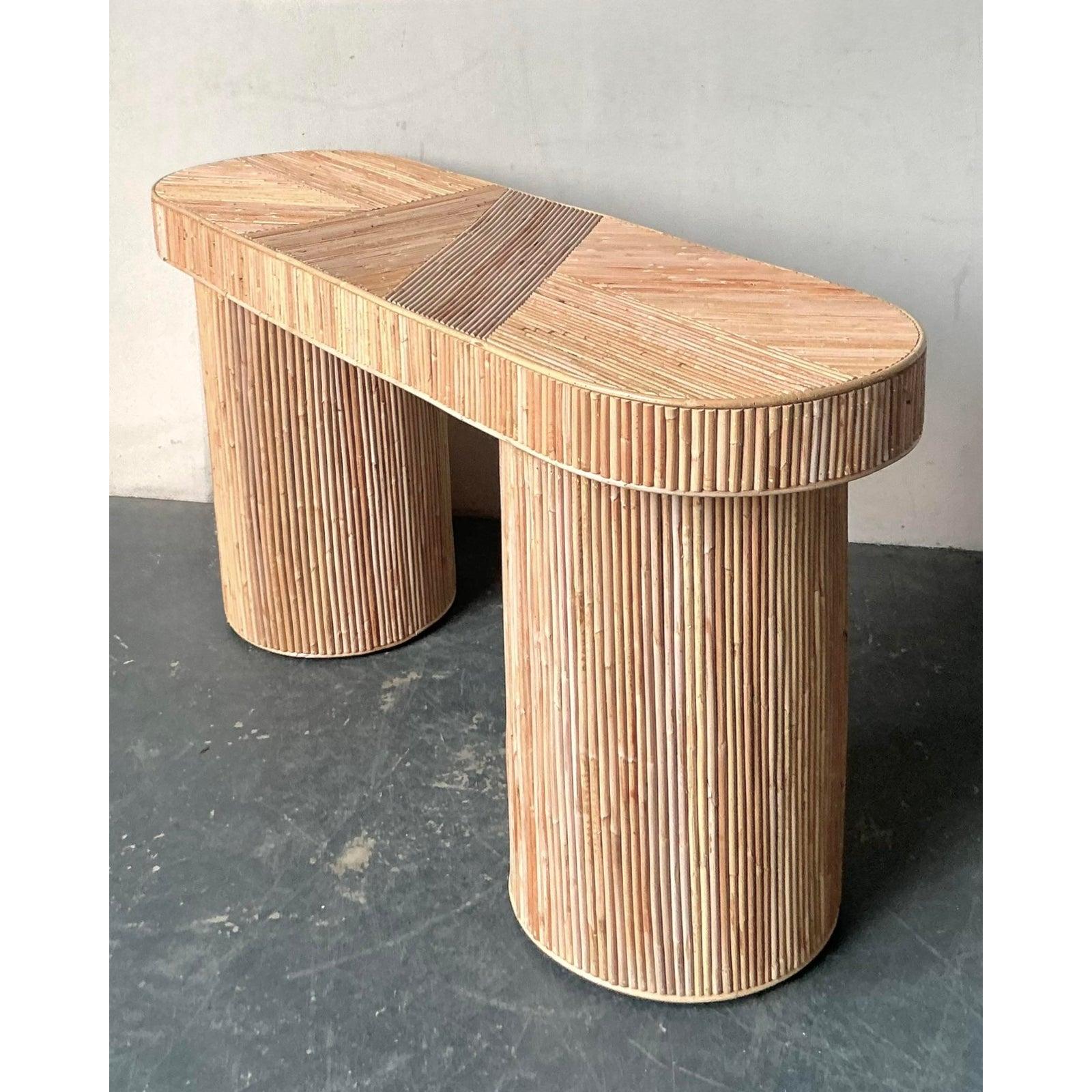 This spectacular console table is a definitive piece of Mid-Century Modern design, celebrating natural materials with structural innovation. The elongated oval top and the dual cylindrical pedestal bases are entirely clad in meticulously aligned