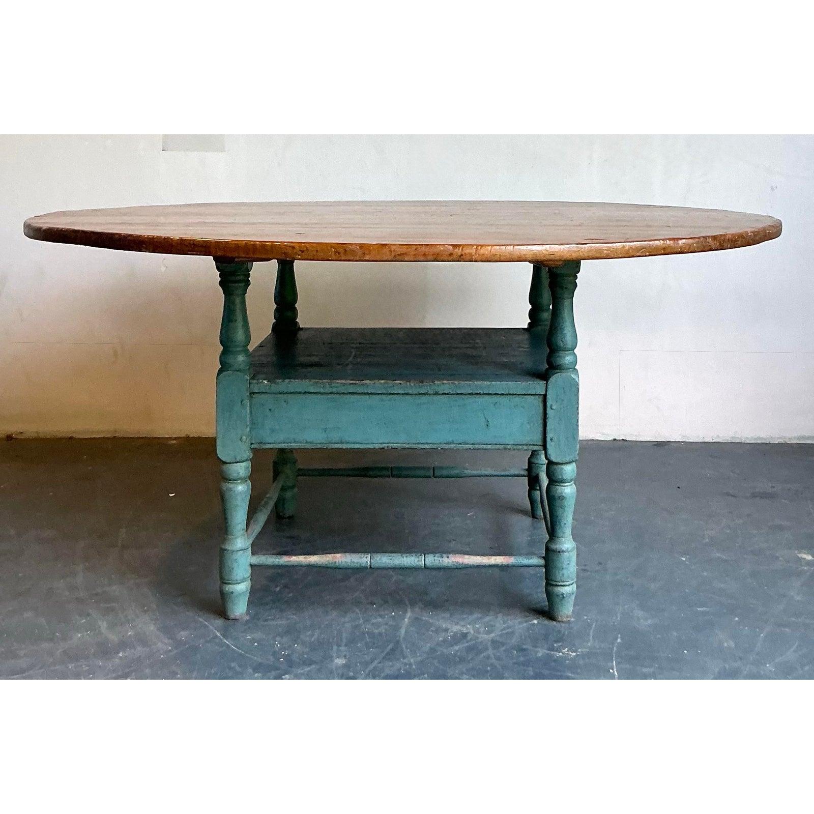 Brimming with authentic rustic charm, this magnificent plank-top dining table is a true showstopper. The massive, circular top is crafted from warm, honey-toned wood, showcasing a rich grain and a lifetime of stories within its surface. This natural