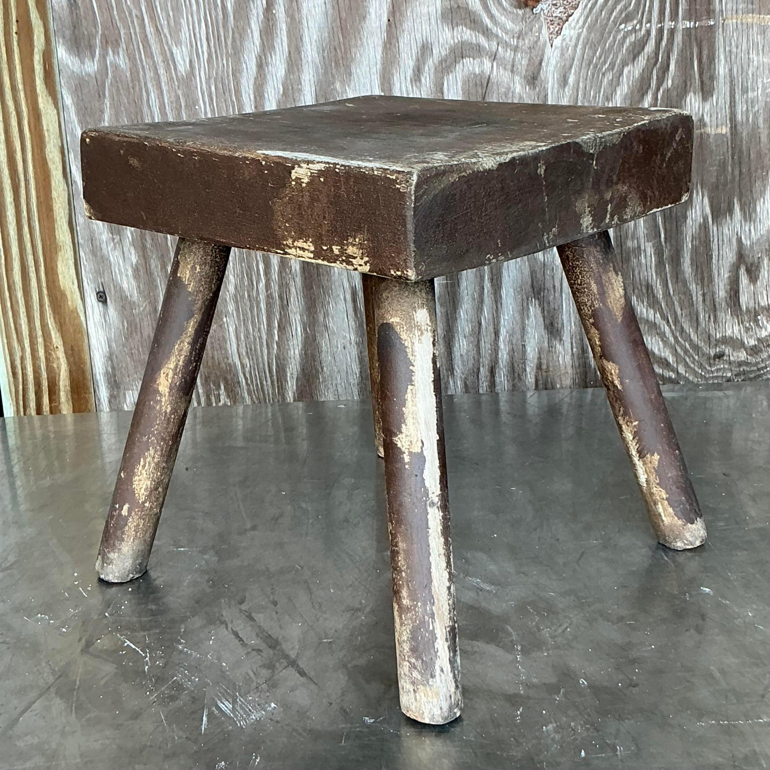 Add a touch of rustic charm to your decor with this Vintage Boho Primitive Stool. Handcrafted with simple, sturdy lines, this stool features a naturally weathered finish that showcases its age and character. Its minimalist design and rough-hewn look