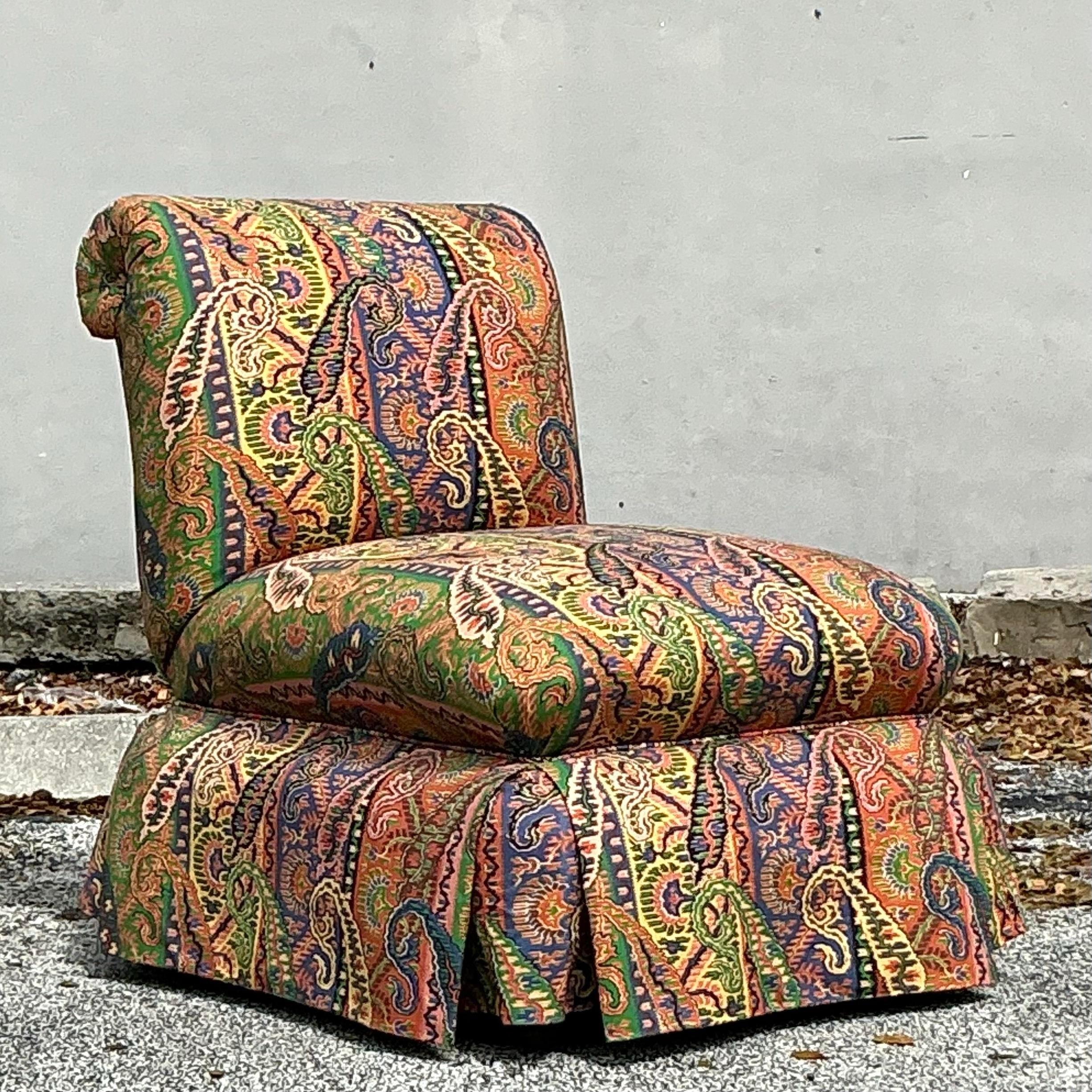 Add a touch of bohemian elegance to your space with this Vintage Boho Printed Paisley Slipper Chair. Upholstered in a vibrant paisley print, this chair is both eye-catching and versatile, making it the perfect accent piece for any room in need of a