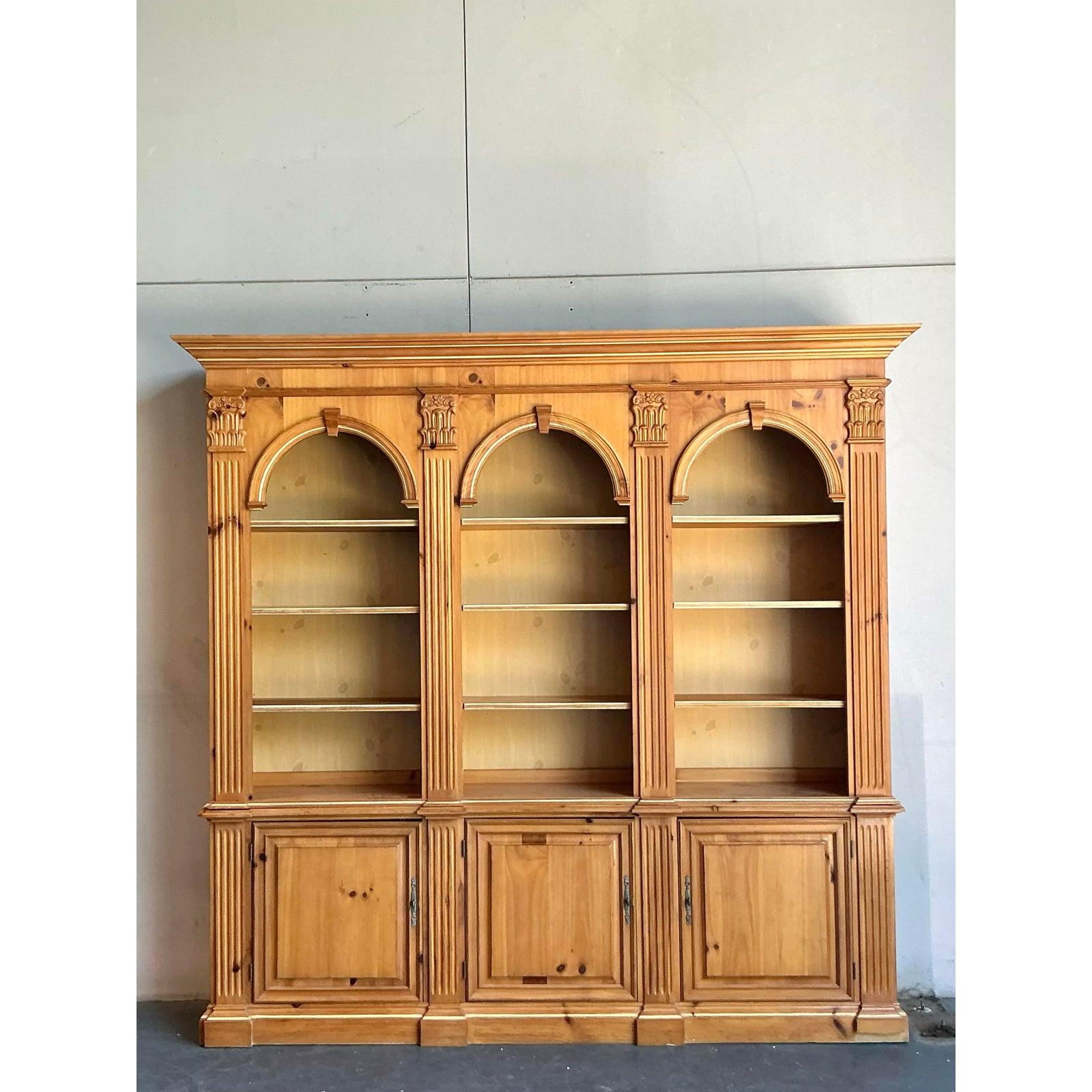 Anchor your living room, library, or study with the monumental presence of this vintage bookcase by renowned American maker, Pulaski. Masterfully crafted from warm, knotty pine, this piece exudes a stately, old-world charm that feels both grand and