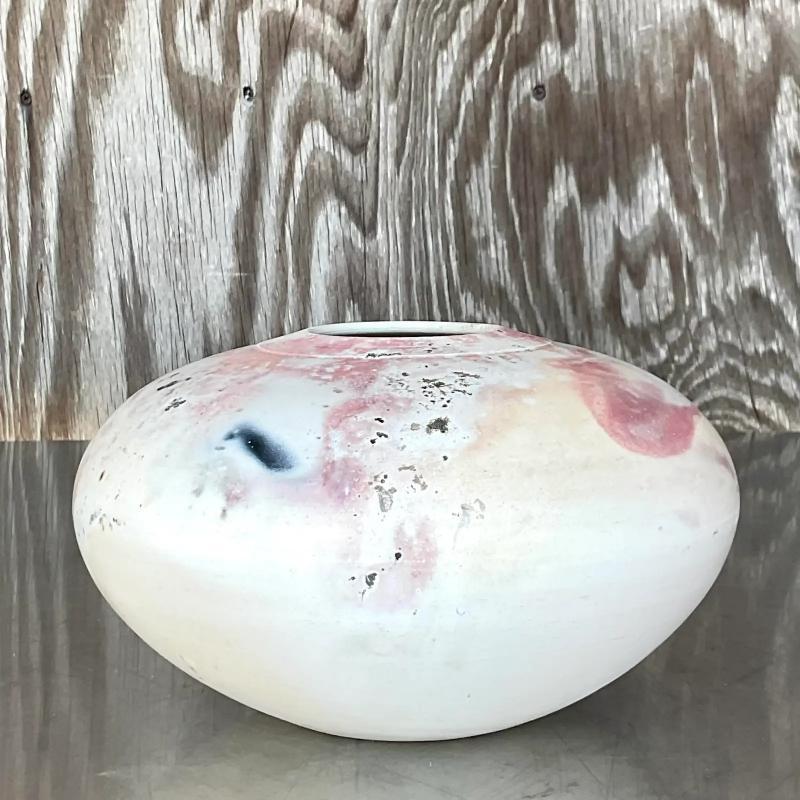 Fantastic vintage Boho studio pottery vase. Beautiful Raku fired piece with flashes of pale pinks and blacks below the matte glaze. Signed on the bottom. Acquired from a Palm Beach estate