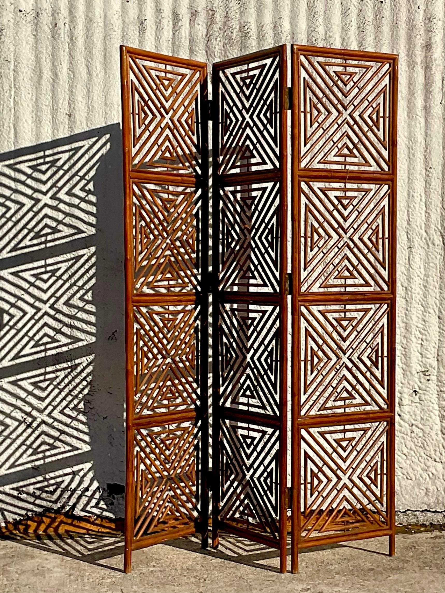 A fabulous vintage Boho folding screen. A chic rattan construction in a graphic square design. Acquired from a Palm Beach estate.