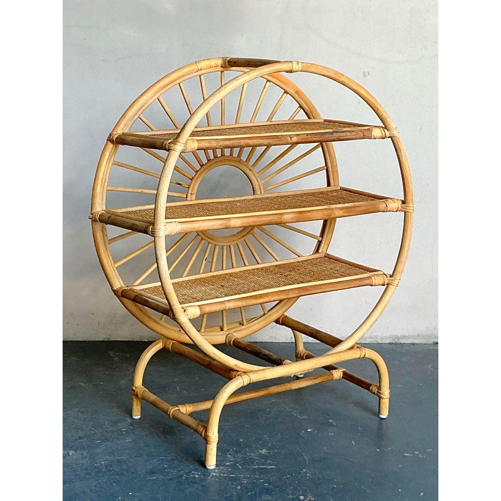 Presenting a charming vintage Boho rattan table top étagère, a delightful piece that embodies the relaxed yet stylish design ethos of the mid-20th century. This exquisite étagère is meticulously crafted from natural rattan, featuring a captivating