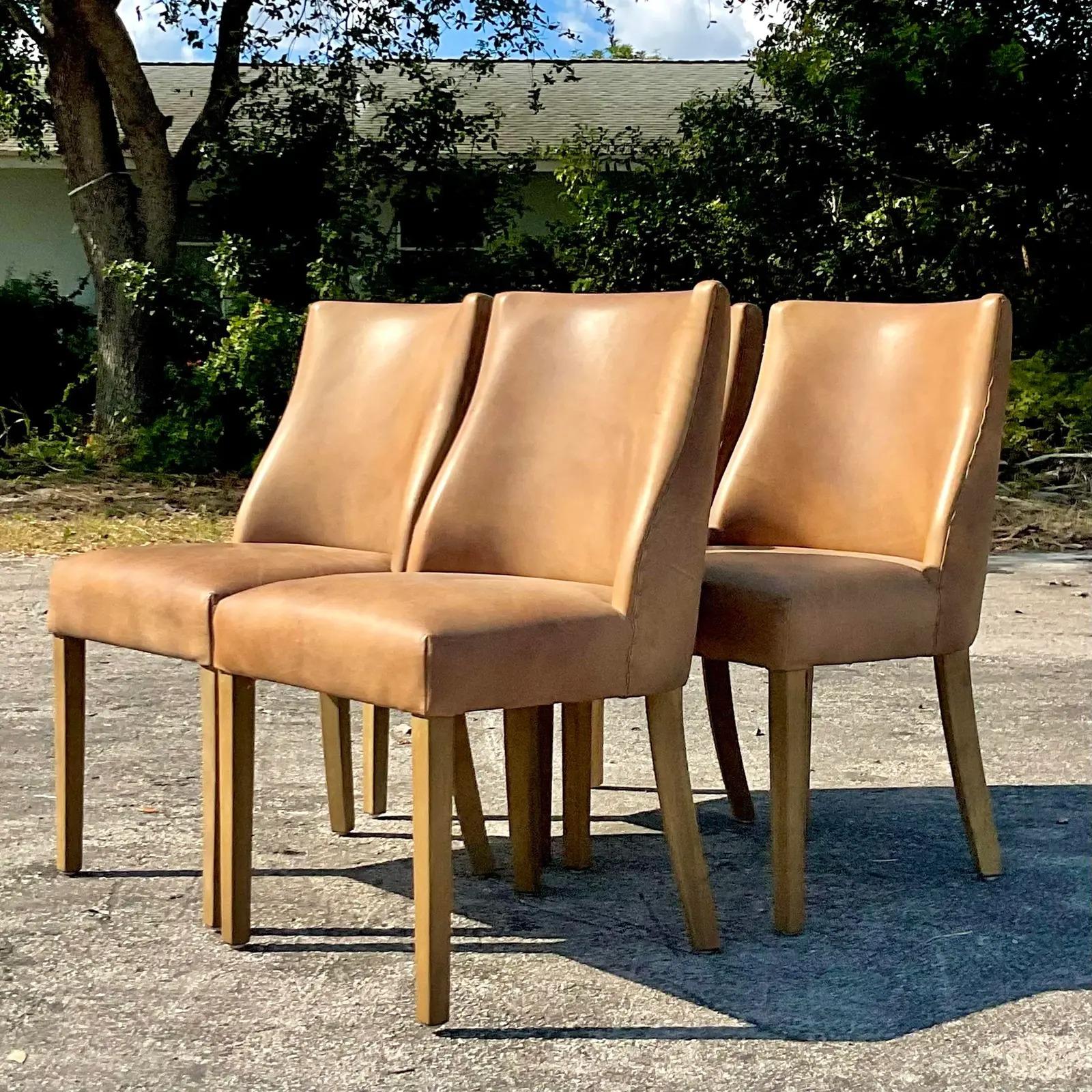 A fabulous set of custom Restoration Hardware dining chairs. Custom leather upholstery with nailhead trim. The popular “Ella” design. Acquired from a Palm Beach estate.