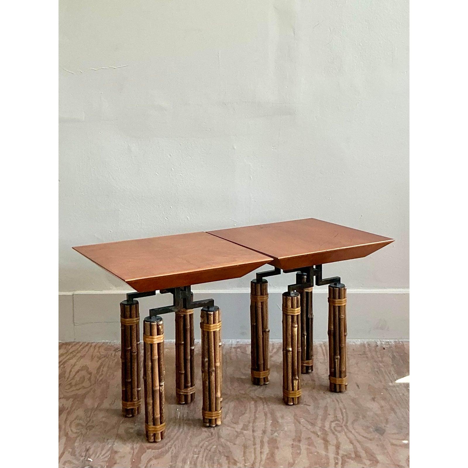 A remarkable pair of side tables designed by Richard Huxley for the iconic McGuire company, this set is a masterful fusion of organic texture and architectural form. The design features a warm, canted tray-like top that appears to float above a