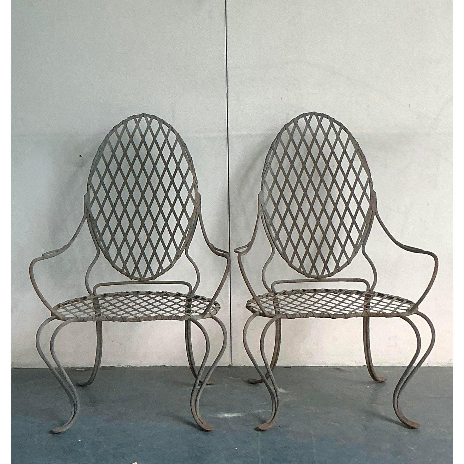 Channeling the romantic, nature-inspired designs of Rose Tarlow, this exceptional pair of lounge chairs brings sculptural artistry to any setting. Masterfully forged from wrought iron, the chairs' frames mimic the organic, flowing lines of